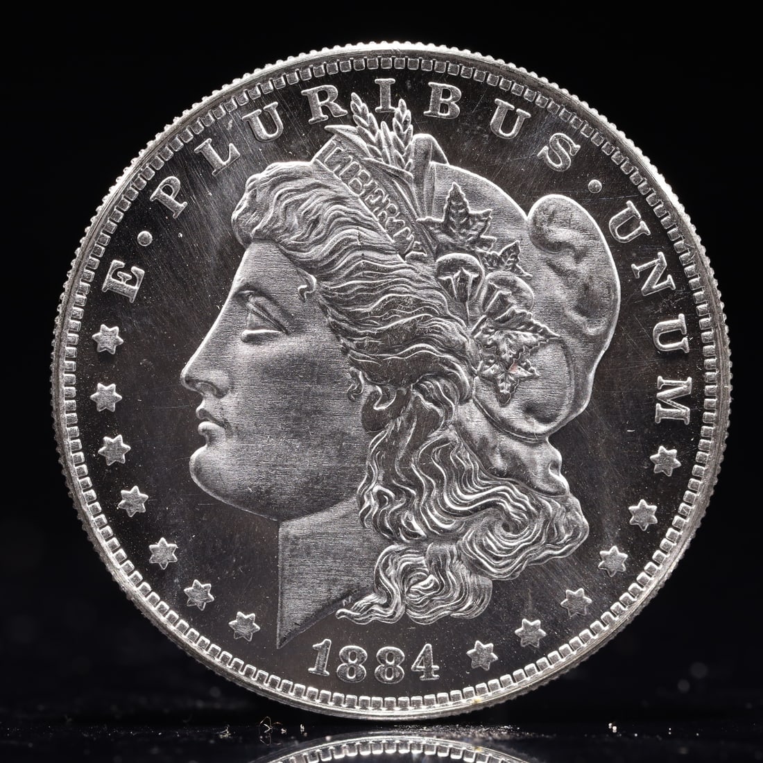 USA Morgan Dollar 1884 Coin: Obv: profile bust with date below and E PLURIBUS UNUM legend and stars around. Rev: eagle with In God we trust above within wreath with UNITED STATES OF AMERICA ONE DOLLAR legend. IN GOD WE TRUST / LI