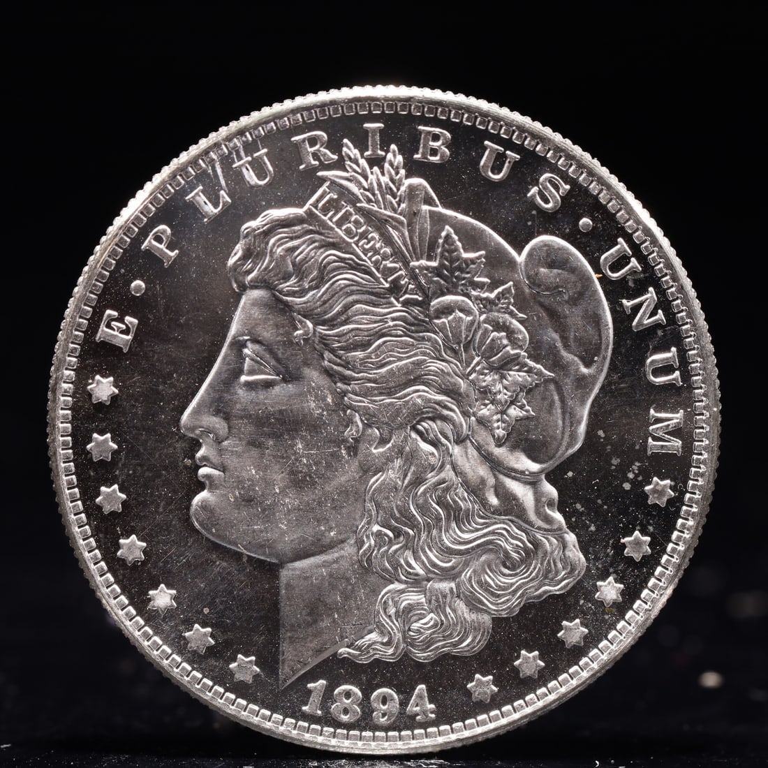 USA Morgan Dollar 1894 Coin: Obv: profile bust with date below and E PLURIBUS UNUM legend and stars around. Rev: eagle with In God we trust above within wreath with UNITED STATES OF AMERICA ONE DOLLAR legend. IN GOD WE TRUST / LI