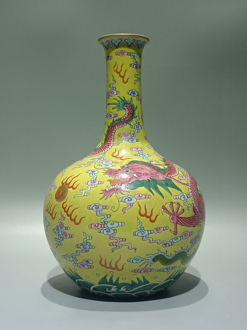 An Exquisite Yellow Ground Famille-Rose Auspicious Cloud and Dragon Pattern Vase: An Exquisite Yellow Ground Famille-Rose Auspicious Cloud and Dragon Pattern Vase,Qing Dynasty,China,Qianlong Six-character Mark,Size:10.4inx6.7in 
