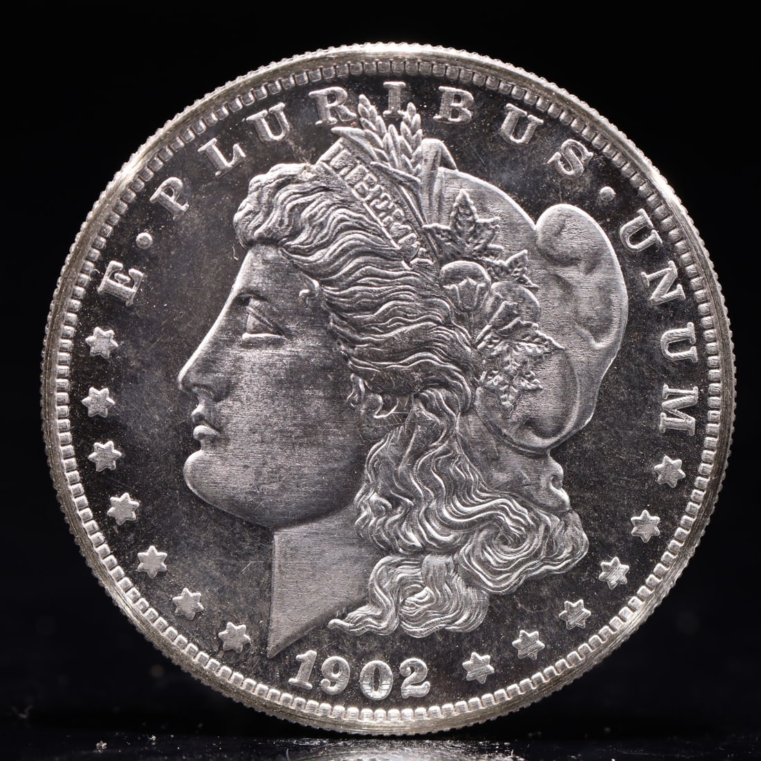 USA Morgan Dollar 1902 Coin: Obv: profile bust with date below and E PLURIBUS UNUM legend and stars around. Rev: eagle with In God we trust above within wreath with UNITED STATES OF AMERICA ONE DOLLAR legend. IN GOD WE TRUST /