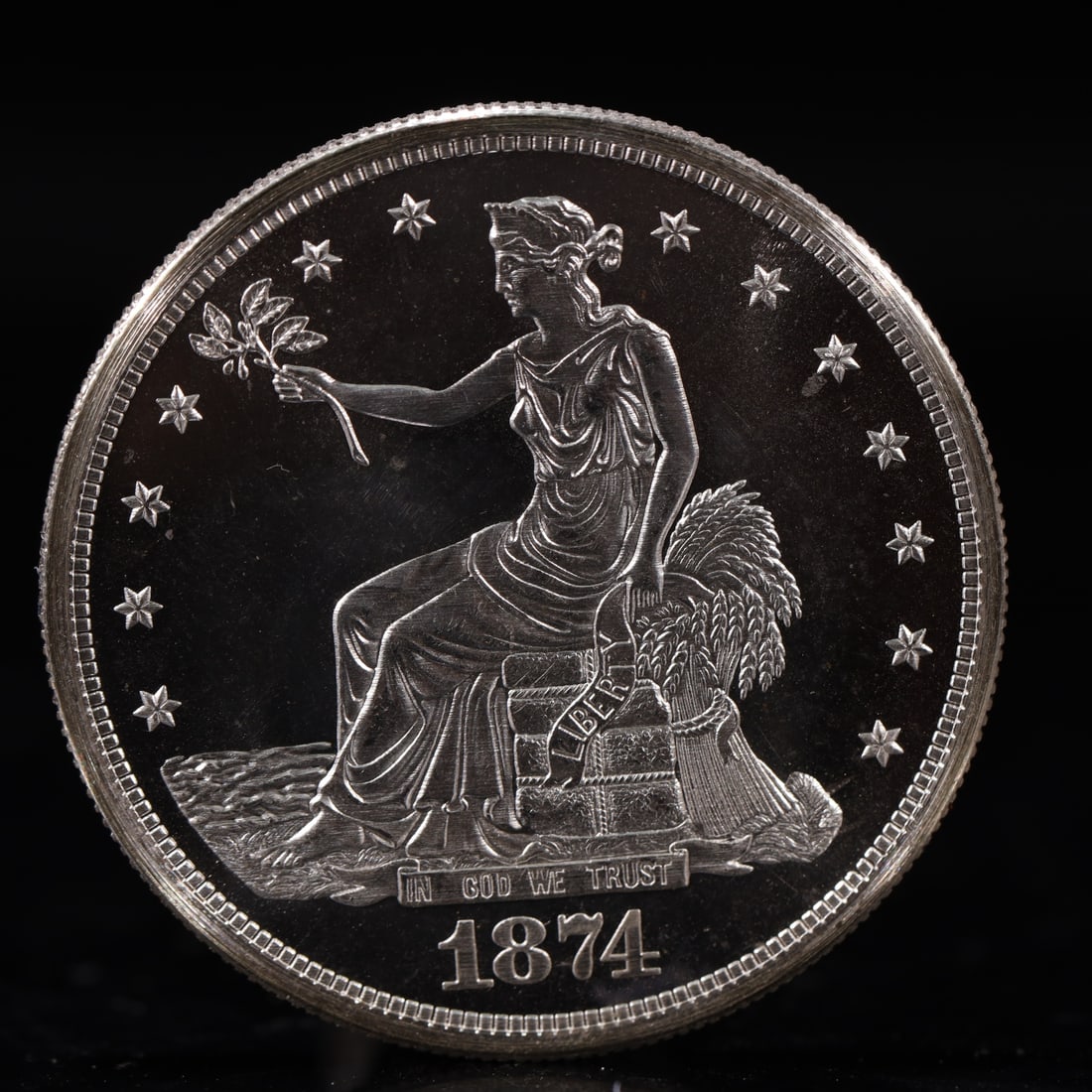 USA Trade Dollar 1874 Coin: American coin. Obverse: Liberty seated on a pedestal facing the sea to the left holding olive branches surrounded by 13 stars. IN GOD WE TRUST / LIBERTY / 1874. Reverse: An eagle holding branches with