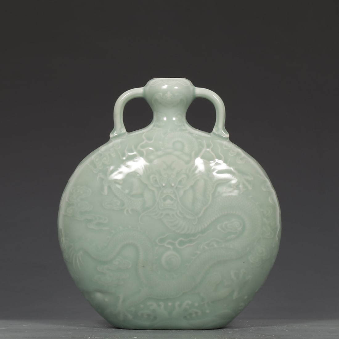 An Exquisite Celadon Glazed Auspicious Cloud and Dragon Pattern Double-Ears Vase: An Exquisite Celadon Glazed Auspicious Cloud and Dragon Pattern Double-Ears Vase,Qing Dynasty,China,Qianlong Six-character Mark,Size:8.7inx7.5in 粉青釉祥云龙纹