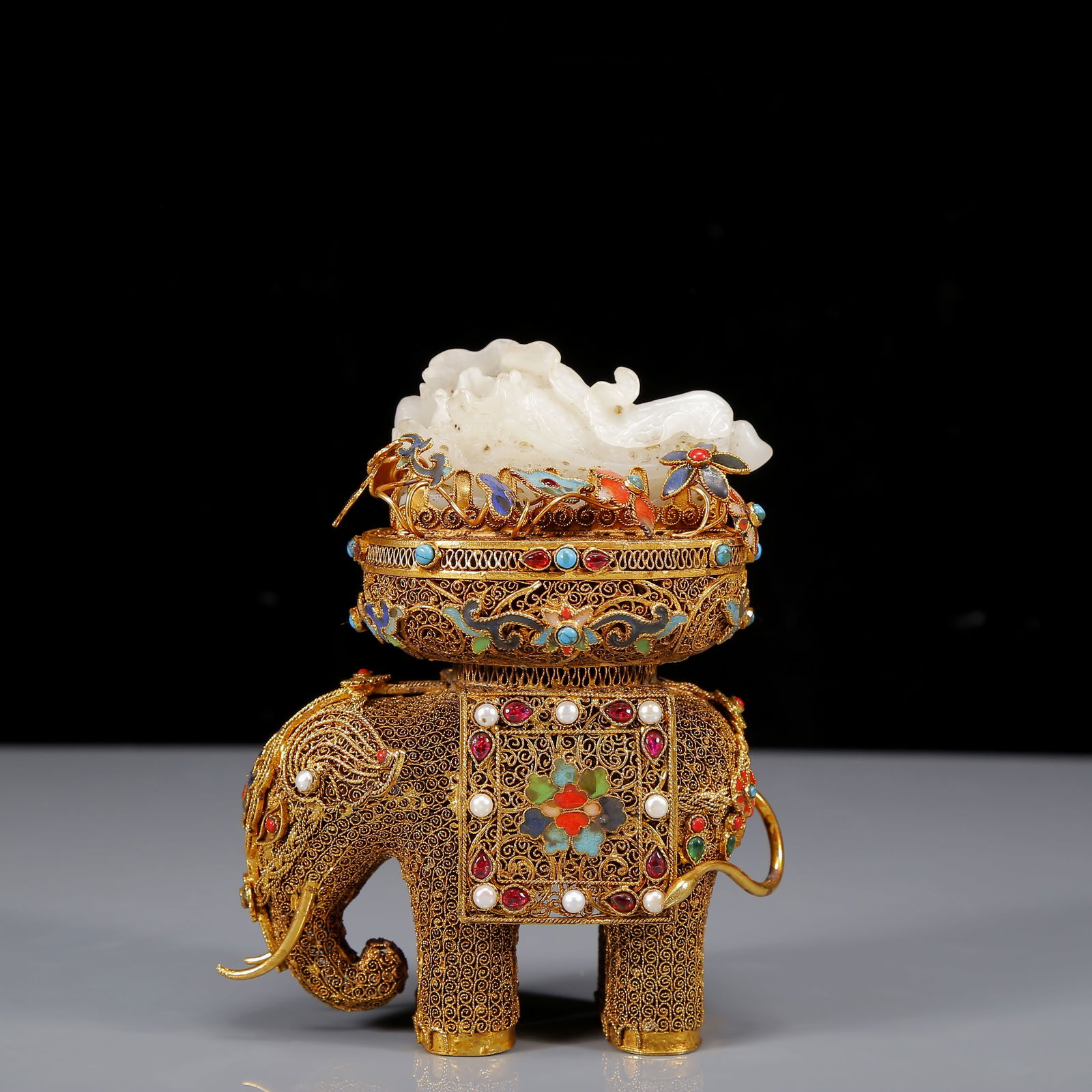 An Exquisite Gilt Inlaid White Jade Elephant Ornament,Inlaid Gems: An Exquisite Gilt Inlaid White Jade Elephant Ornament,Inlaid Gems,Qing Dynasty,China,Qianlong Four-character Mark,Size:4.7inx2.6inx6.3in,Weight:520g 