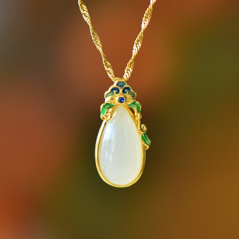 An Exquisite Sterling Silver-Gold Plated Inlaid White Jade Pendant: An Exquisite Sterling Silver-Gold Plated Inlaid White Jade Pendant,Size:0.3inx0.6in 纯银镀金镶白玉吊坠