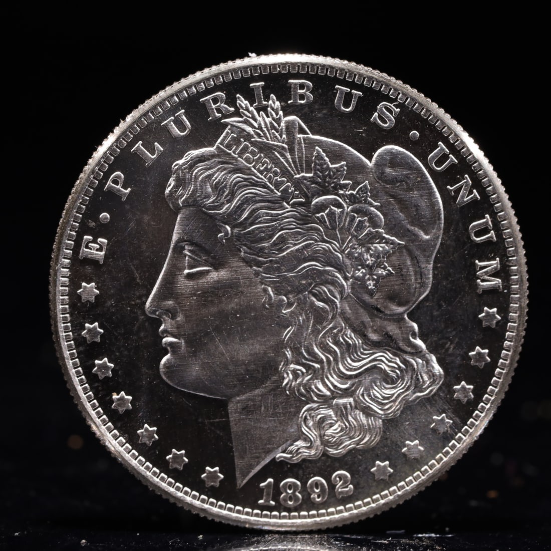 USA Morgan Dollar 1892 Coin: Obv: profile bust with date below and E PLURIBUS UNUM legend and stars around. Rev: eagle with In God we trust above within wreath with UNITED STATES OF AMERICA ONE DOLLAR legend. IN GOD WE TRUST /