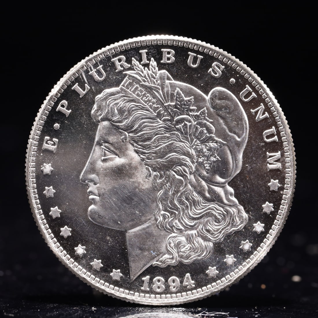 USA Morgan Dollar 1894 Coin: Obv: profile bust with date below and E PLURIBUS UNUM legend and stars around. Rev: eagle with In God we trust above within wreath with UNITED STATES OF AMERICA ONE DOLLAR legend. IN GOD WE TRUST /
