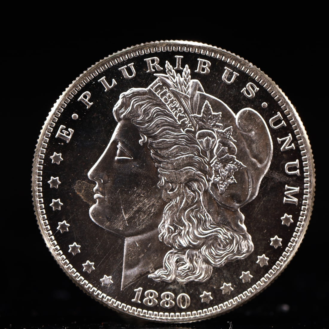 USA Morgan Dollar 1880 Coin: Obv: profile bust with date below and E PLURIBUS UNUM legend and stars around. Rev: eagle with In God we trust above within wreath with UNITED STATES OF AMERICA ONE DOLLAR legend. IN GOD WE TRUST / LI