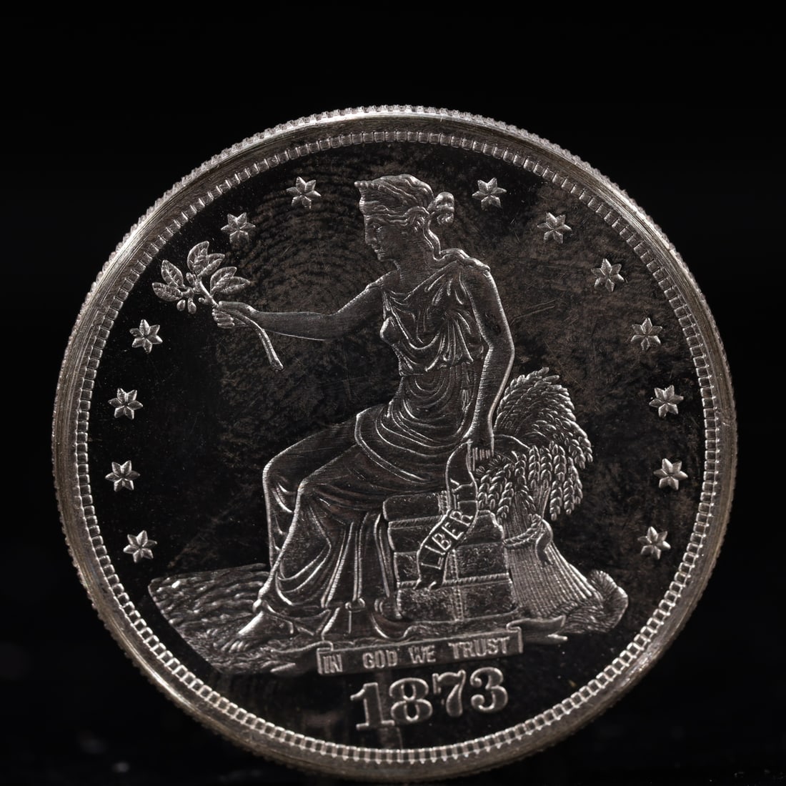 USA Trade Dollar 1873 Coin: American coin. Obverse: Liberty seated on a pedestal facing the sea to the left holding olive branches surrounded by 13 stars. IN GOD WE TRUST / LIBERTY / 1873. Reverse: An eagle holding branches