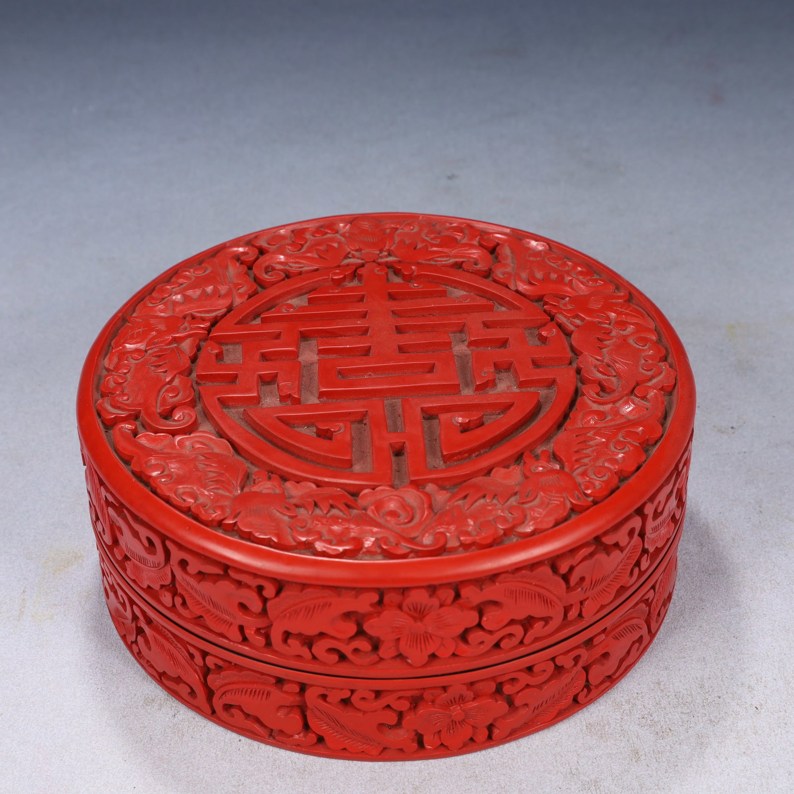 An Exquisite Carved Red Lacquer Flower,Bats and Peach Pattern Cover Box: An Exquisite Carved Red Lacquer Flower,Bats and Peach Pattern Cover Box,Qing Dynasty, China,Size:7.1inx2.8in,Weight:550g 剔红漆花卉福寿纹盖盒