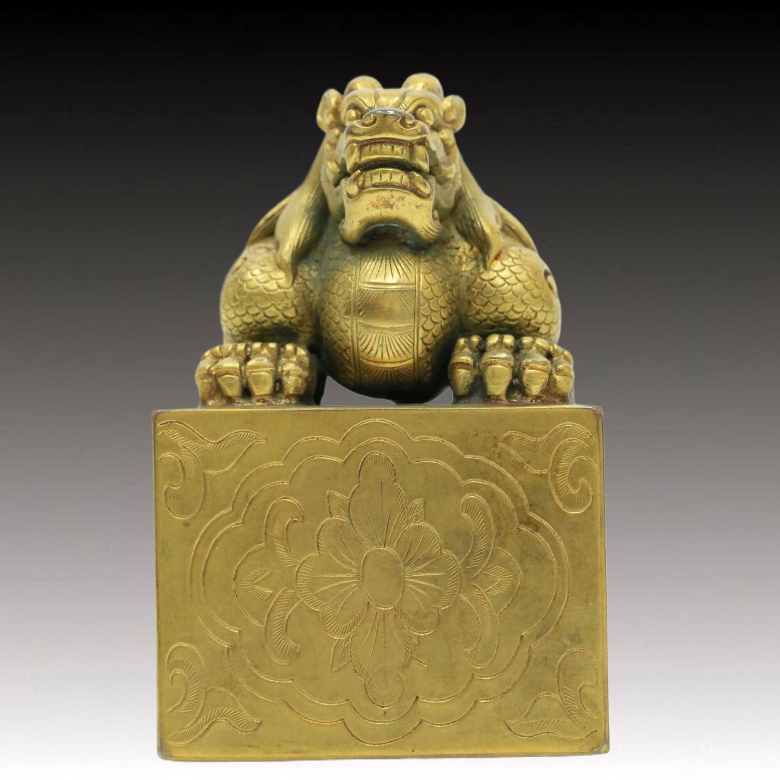 A Brilliant Gilt-Bronze 'Flower& Dragon' Seal: Brilliant Gilt-Bronze 'Flower& Dragon' Seal. The scaly dragon is cast with rounded, bulging eyes, open mouth, revealing fangs, mane detailed with fine hair incisions. Chinese Qing Dynasty. Size:3inx4.