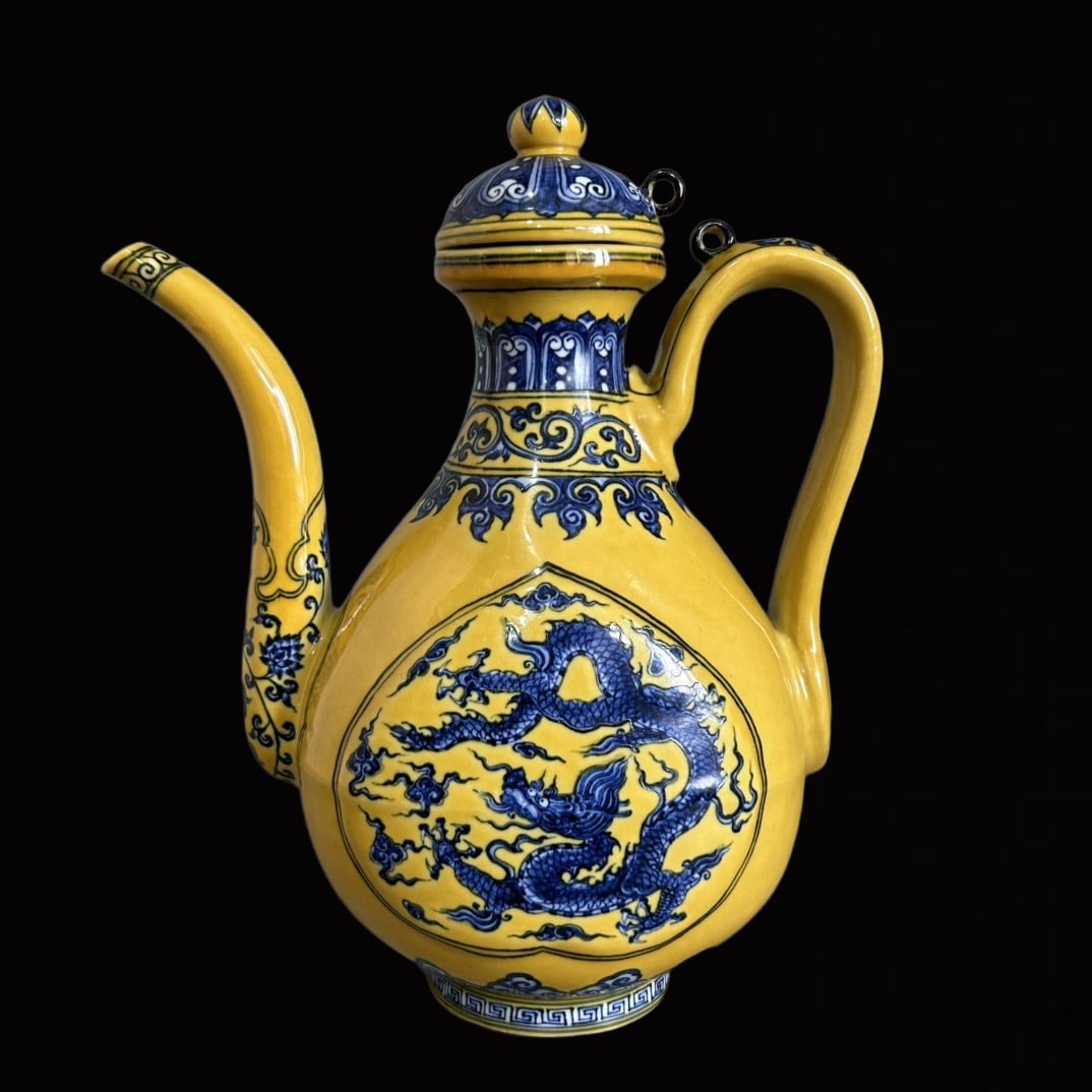 An Exquisite Yellow Ground Blue and White Auspicious Cloud and Dragon Pattern Ewer: An Exquisite Yellow Ground Blue and White Auspicious Cloud and Dragon Pattern Ewer,Qing Dynasty,China,Size:6.7inx9.2in