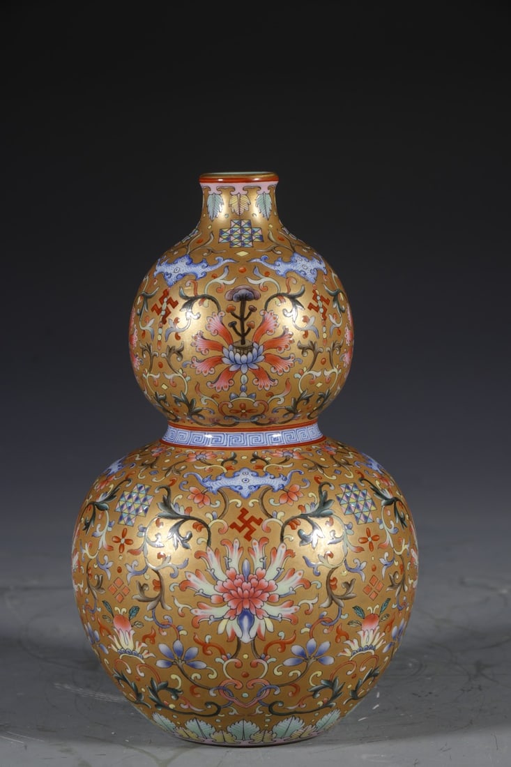 An Exquisite Gold Ground Enamel Lotus Pattern Gourd-Shaped Vase: An Exquisite Gold Ground Enamel Lotus Pattern Gourd-Shaped Vase,Qing Dynasty,China,Qianlong Four-character Mark,Size:8.5inx2.6in 金地珐琅彩缠枝莲纹