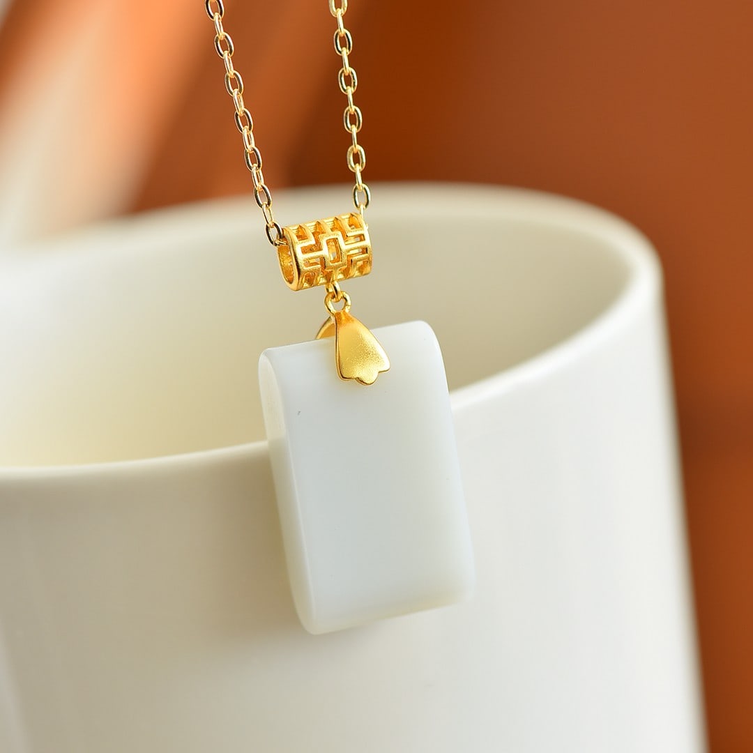 An Exquisite Sterling Silver-Gold Plated Inlaid White Jade Pendant: Sterling Silver-Gold Plated Inlaid White Jade Pendant , Size :0.6inx1in 纯银镀金镶白玉吊坠,尺寸:0.6inx1in