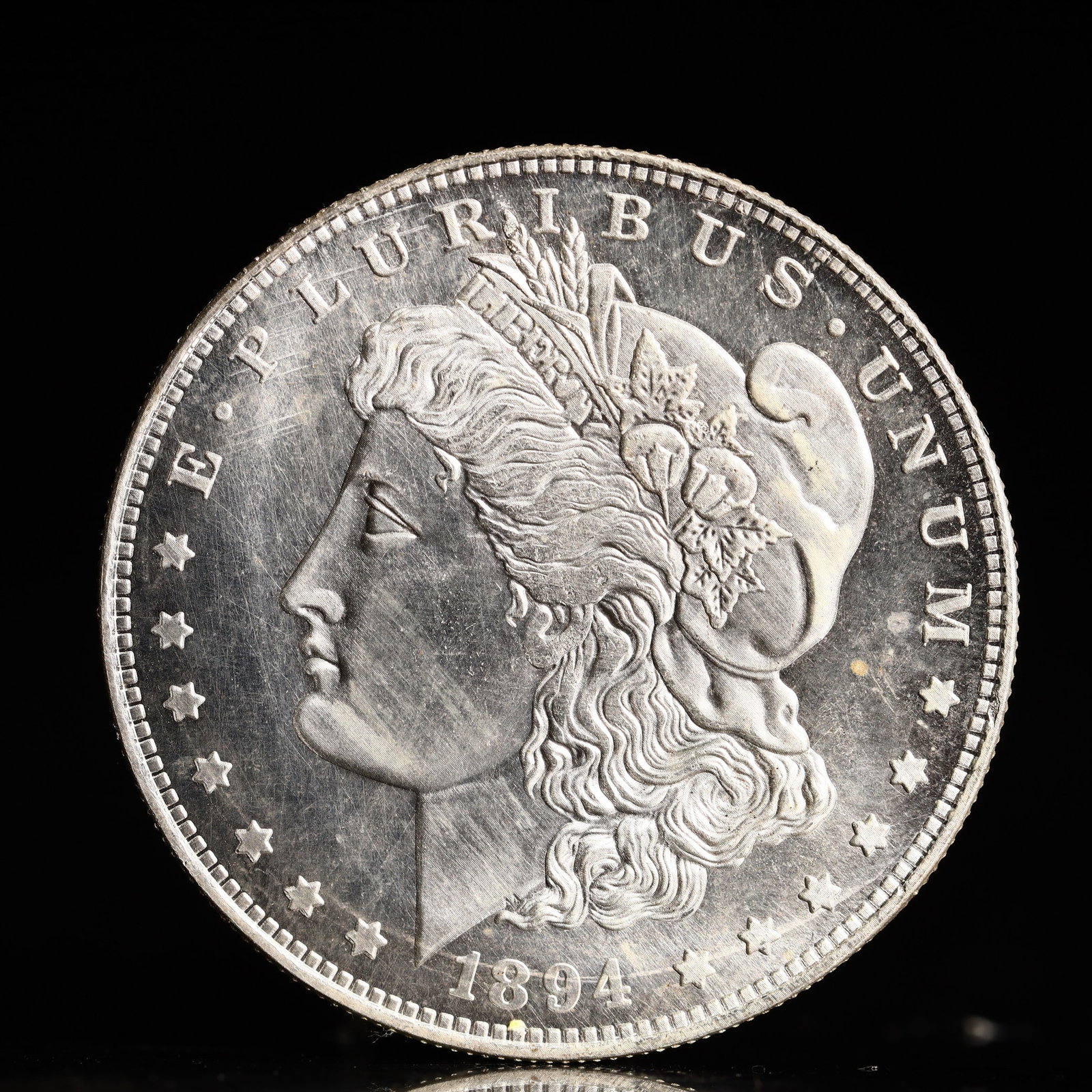USA Morgan Dollar 1894 Coin: Obv: profile bust with date below and E PLURIBUS UNUM legend and stars around. Rev: eagle with In God we trust above within wreath with UNITED STATES OF AMERICA ONE DOLLAR legend. IN GOD WE TRUST /