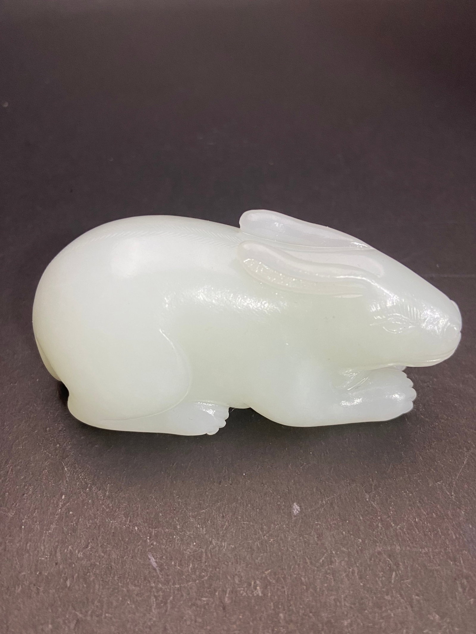 An Exquisite White Jade Rabbit Hand Piece: An Exquisite White Jade Rabbit Hand Piece,Qing Dynasty,China,Size:76.7mmx36.5mmx37mm,Weight:154g 白玉兔手把件,中国清代