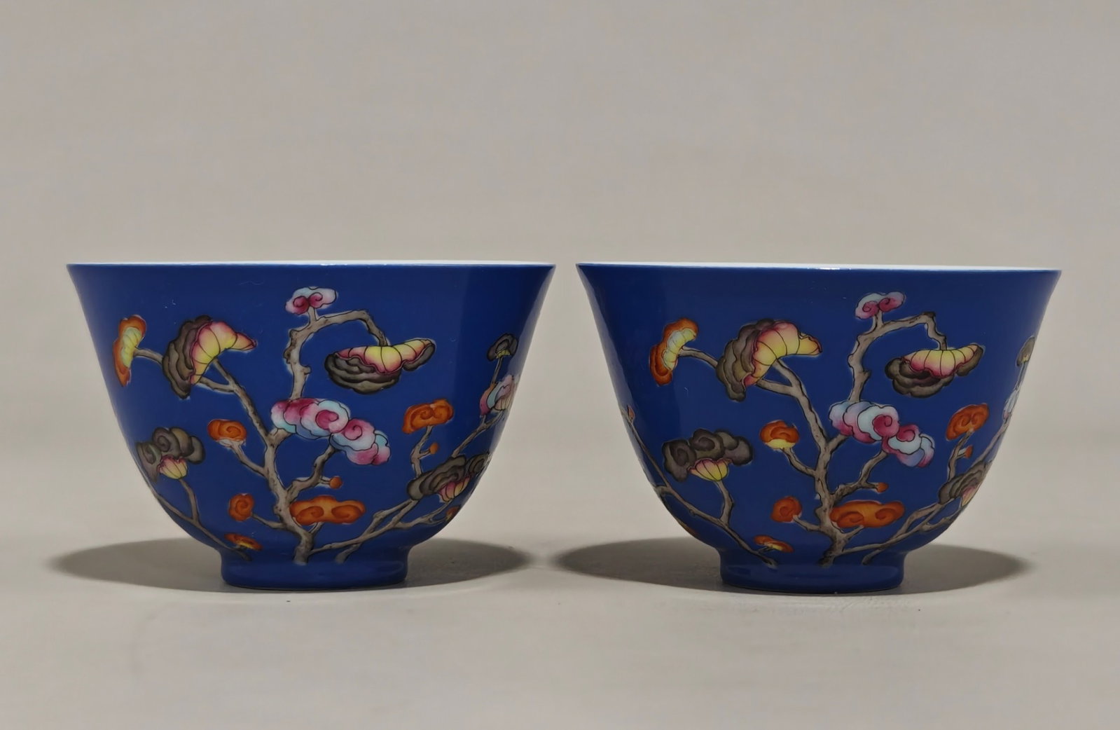 A Pair of Exquisite Blue Glazed Famille-Rose Bats and Ganoderma lucidum Pattern Cups: A Pair of Exquisite Blue Glazed Famille-Rose Bats and Ganoderma lucidum Pattern Cups,Qing Dynasty,China,Yongzheng Four-character Mark,Size:2inx2.9in 一对蓝釉粉彩
