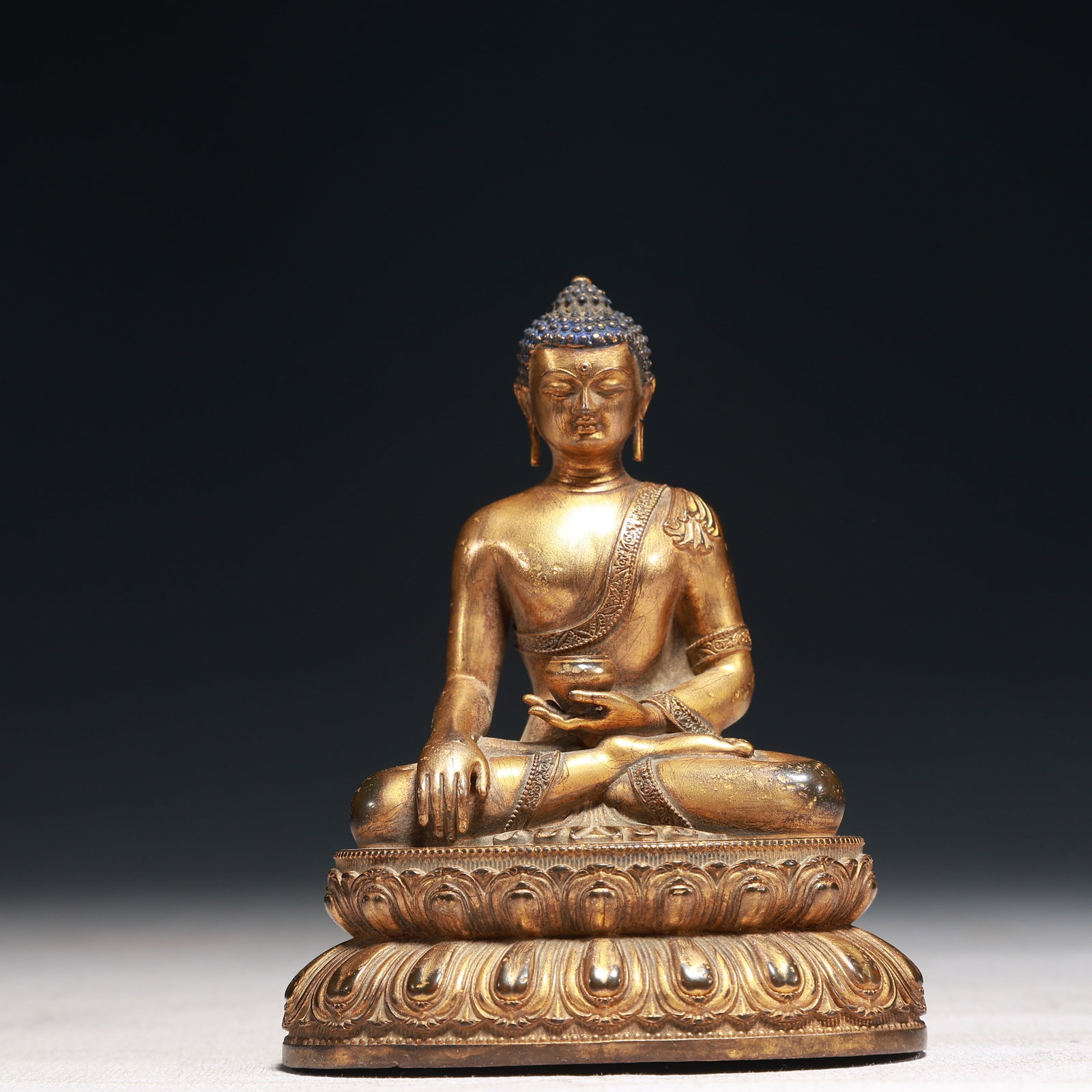 A Solemn Gilt Bronze Statue of Sakyamuni: A Solemn Gilt Bronze Statue of Sakyamuni,Qing Dynasty,China,Size:3.1inx2.2inx3.9in,Weight:250g 铜鎏金释迦摩尼像,中国清代