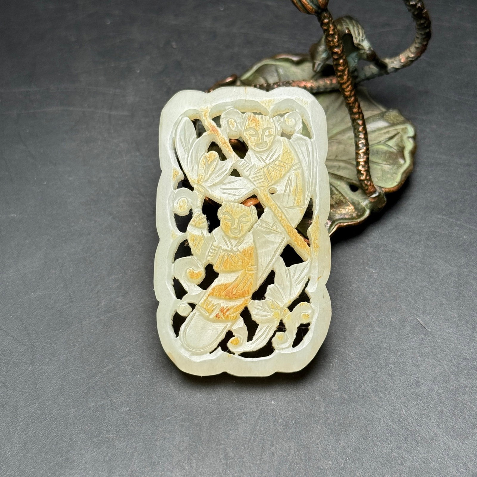 An Exquisite White Jade Hollow Lotus and Figure Pattern Pendant: An Exquisite White Jade Hollow Lotus and Figure Pattern Pendant,Qing Dynasty,China,Size:34mmx56mmx6mm,Weight:23g 白玉镂空莲花人物纹挂件
