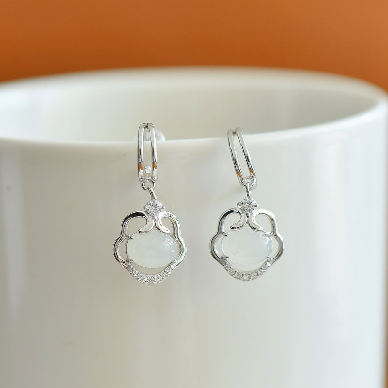 A Pair of Exquisite Sterling Silver Inlaid White Jade Earrings: A Pair of Exquisite Sterling Silver Inlaid White Jade Earrings,Size:6mmx8mm 一对精美的纯银镶白玉耳环