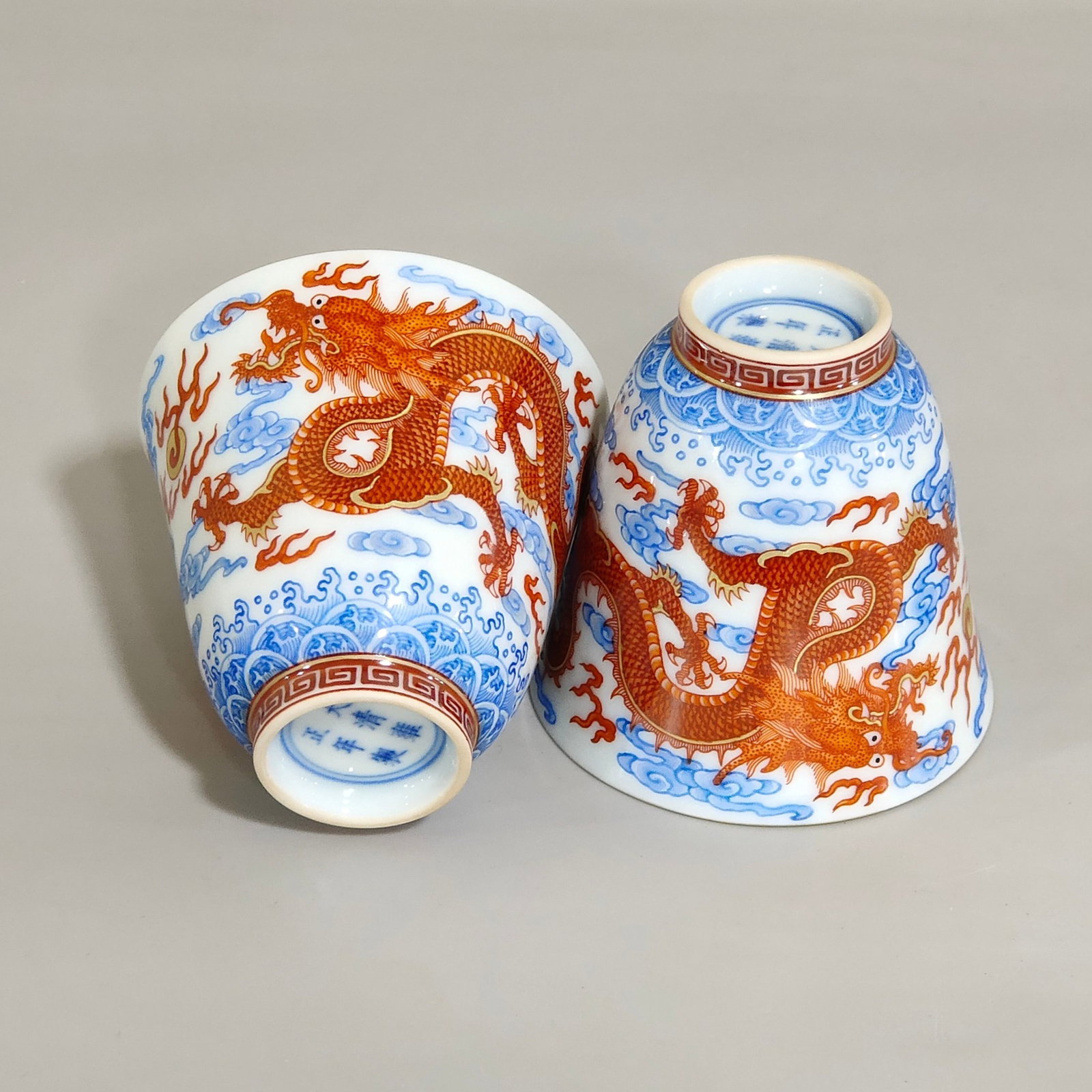A Pair of Exquisite Blue and White Iron-Red Auspicious Cloud,Dragon and Phoenix Pattern Cups: A Pair of Exquisite Blue and White Iron-Red Auspicious Cloud,Dragon and Phoenix Pattern Cups,Qing Dynasty,China,Yongzheng Six-character Mark,Size:2.2inx2.5in 一对青花矾&#