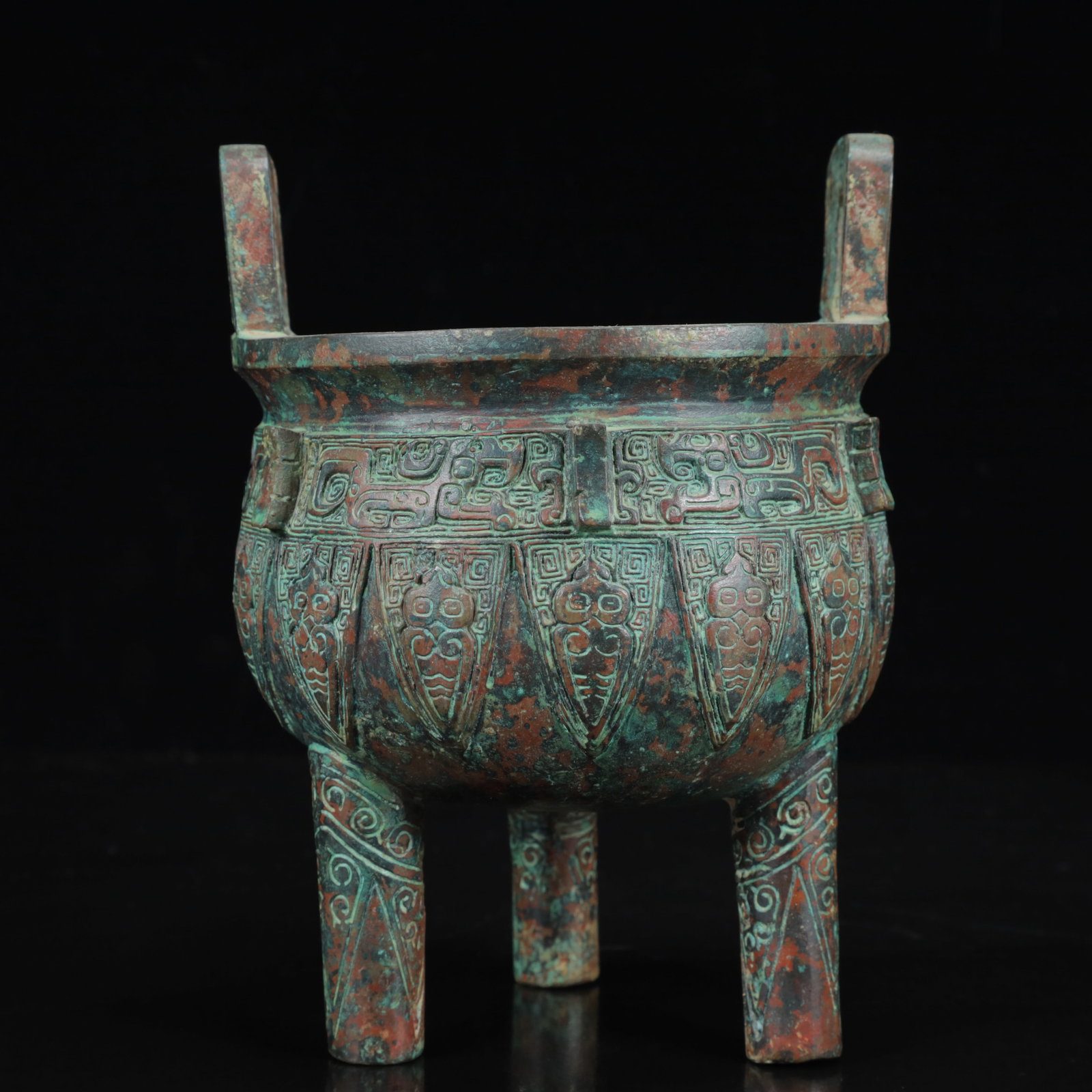 An Archaic Bronze Figure-Face Pattern Double-Ears and Tripod Censer: An Archaic Bronze Figure-Face Pattern Double-Ears and Tripod Censer,the Warring States Period in China,Size:5.5inx7.5in,Weight:1300g 青铜人面纹双耳三