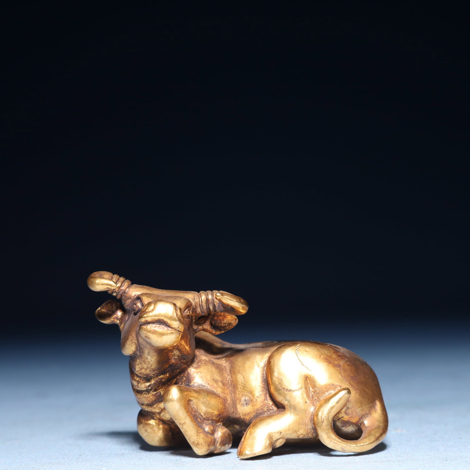 An Exquisite Gilt Bronze Buffalo Ornament: An Exquisite Gilt Bronze Buffalo Ornament,Qing Dynasty,China,Size:2.4inx1.6inx1.4in,Weight:300g 铜鎏金牛摆件,中国清代