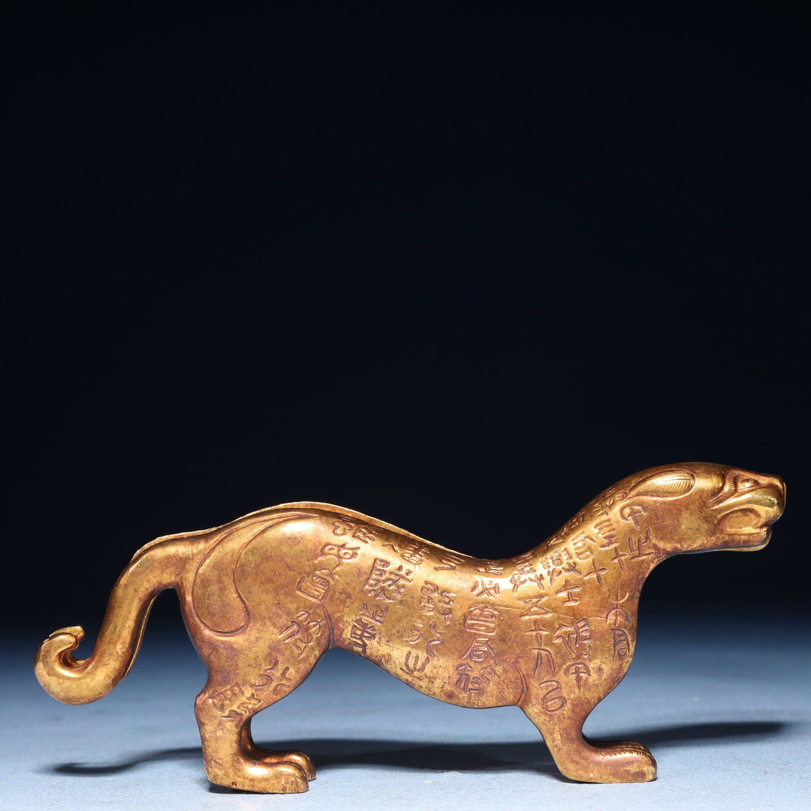 An Exquisite Gilt Bronze Beast Ornament,With Inscription: An Exquisite Gilt Bronze Beast Ornament,With Inscription,Qing Dynasty,China,Size:5.9inx0.8inx2.4in,Weight:450g 铜鎏金兽摆件,带铭文,中国