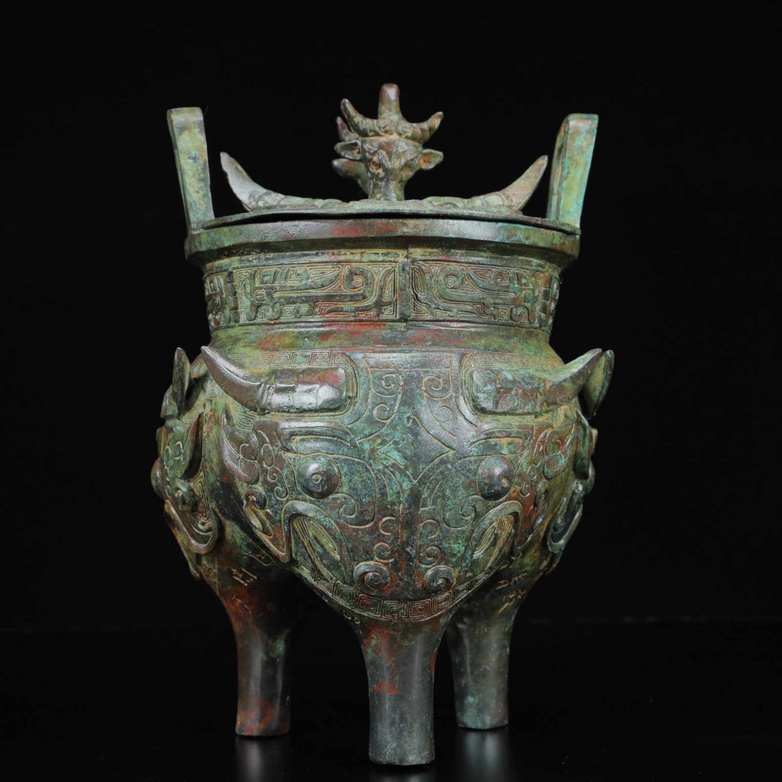 An Archaic Bronze Figure-Face Pattern Double-Ears and Tripod Censer,with Inscription: An Archaic Bronze Figure-Face Pattern Double-Ears and Tripod Censer,with Inscription,the Warring States Period in China,Size:5.5inx8.7in,Weight:2400g 青铜人面纹双&#