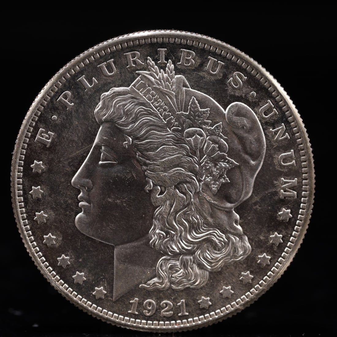 USA Morgan Dollar 1921 Coin: Obv: profile bust with date below and E PLURIBUS UNUM legend and stars around. Rev: eagle with In God we trust above within wreath with UNITED STATES OF AMERICA ONE DOLLAR legend. IN GOD WE TRUST /
