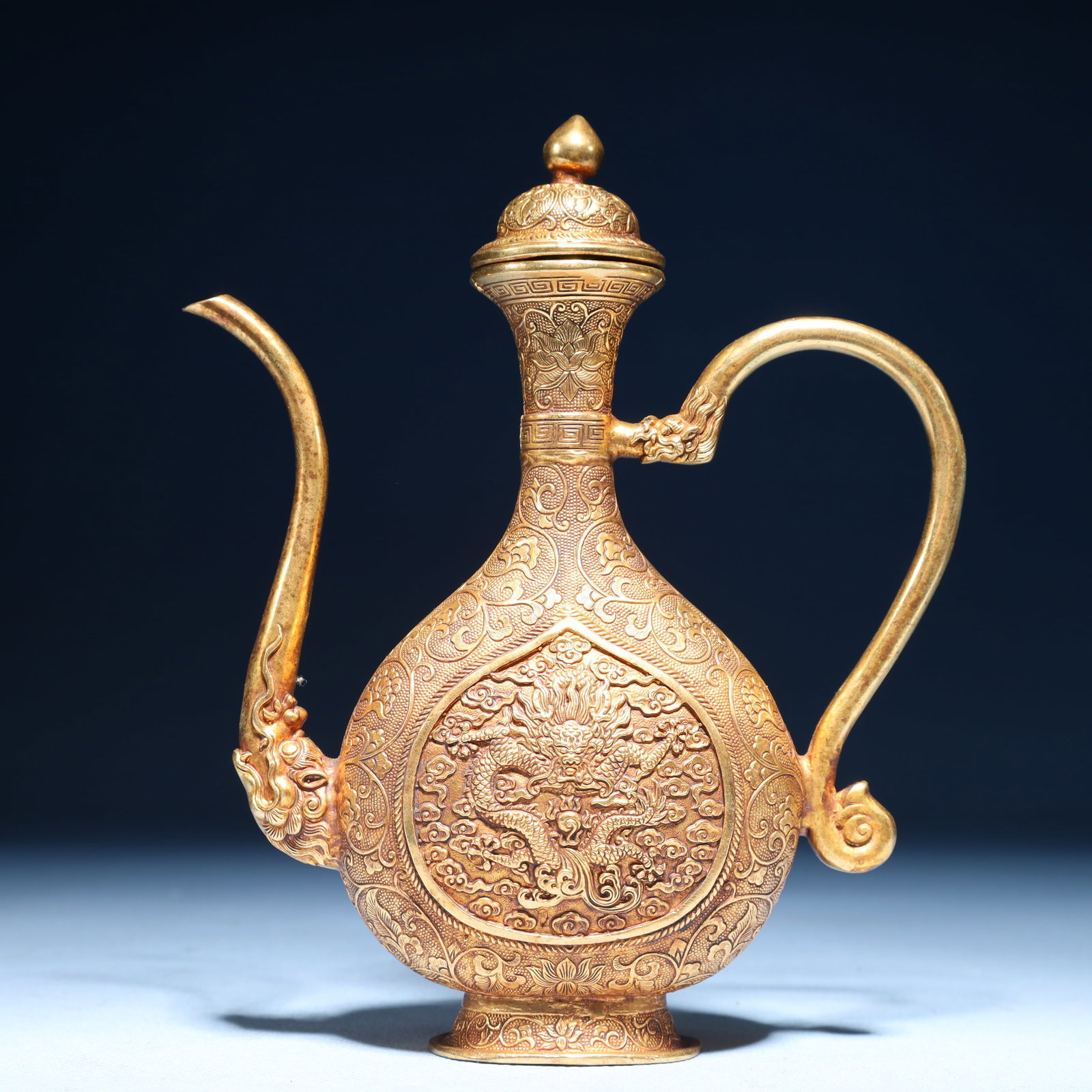 An Exquisite Gilt Bronze Auspicious Cloud and Dragon Pattern Ewer: An Exquisite Gilt Bronze Auspicious Cloud and Dragon Pattern Ewer,Qing Dynasty,China,Size:5.1inx1.6inx6.5in,Weight:350g 铜鎏金祥云龙纹执壶,中