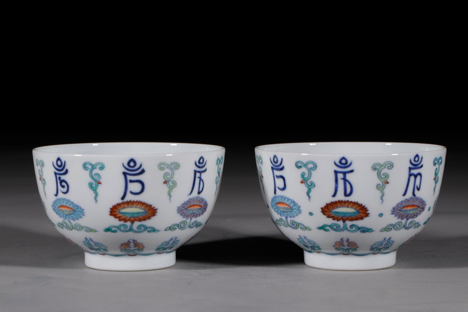 A Pair of Exquisite Blue and White Doucai Lotus Pattern Bowls,With Sanskrit: A Pair of Exquisite Blue and White Doucai Lotus Pattern Bowls,With Sanskrit,Qing Dynasty,China,Yongzheng Six-character Mark,Size:2.6inx4.1in 一对青花斗彩缠