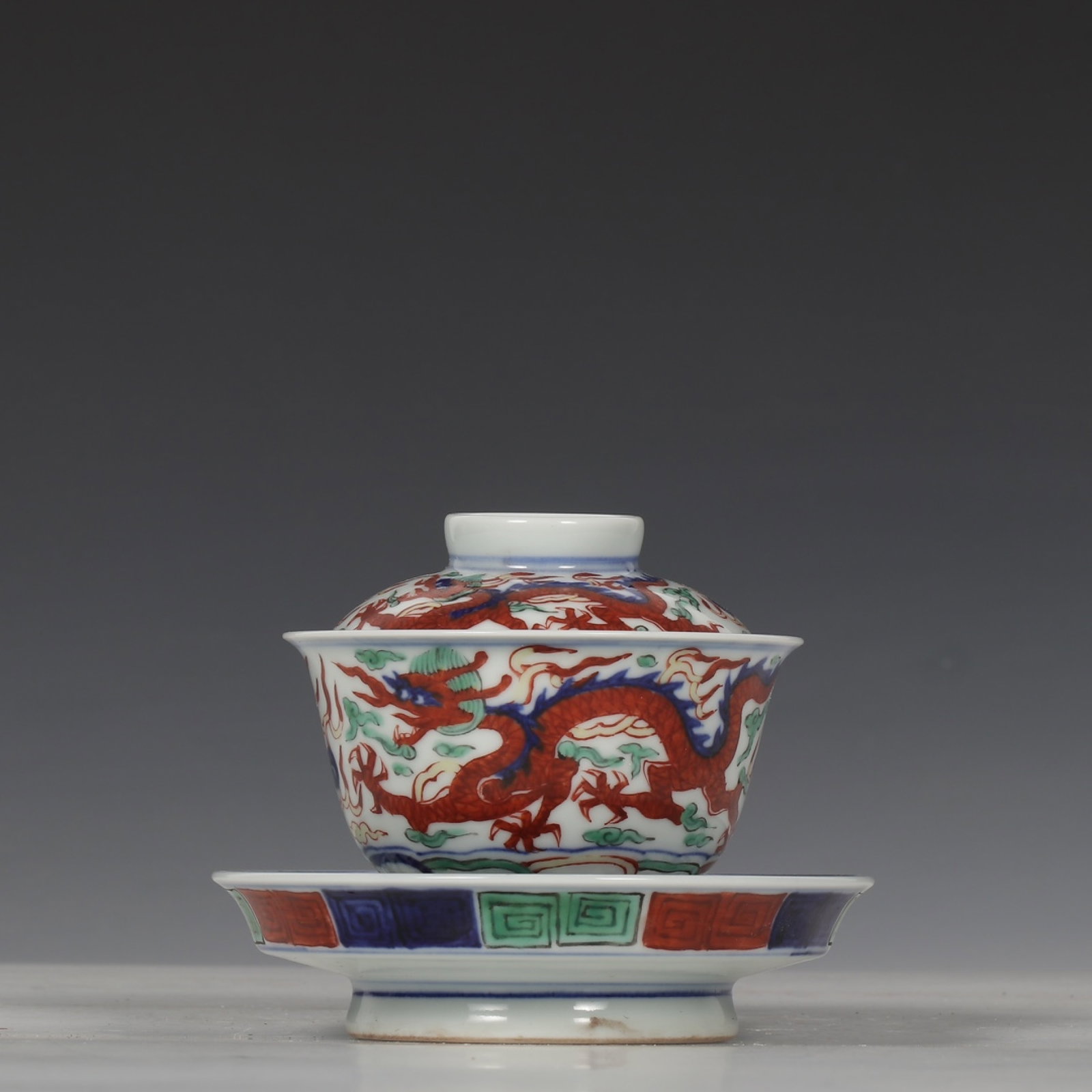 An Exquisite Wucai Auspicious Cloud and Dragon Pattern Bowl with Cover,with Plate: An Exquisite Wucai Auspicious Cloud and Dragon Pattern Bowl with Cover,with Plate,Ming Dynasty,China,Jiajing Six-character Mark,Size:3.9inx4.6in 五彩祥云龙纹盖