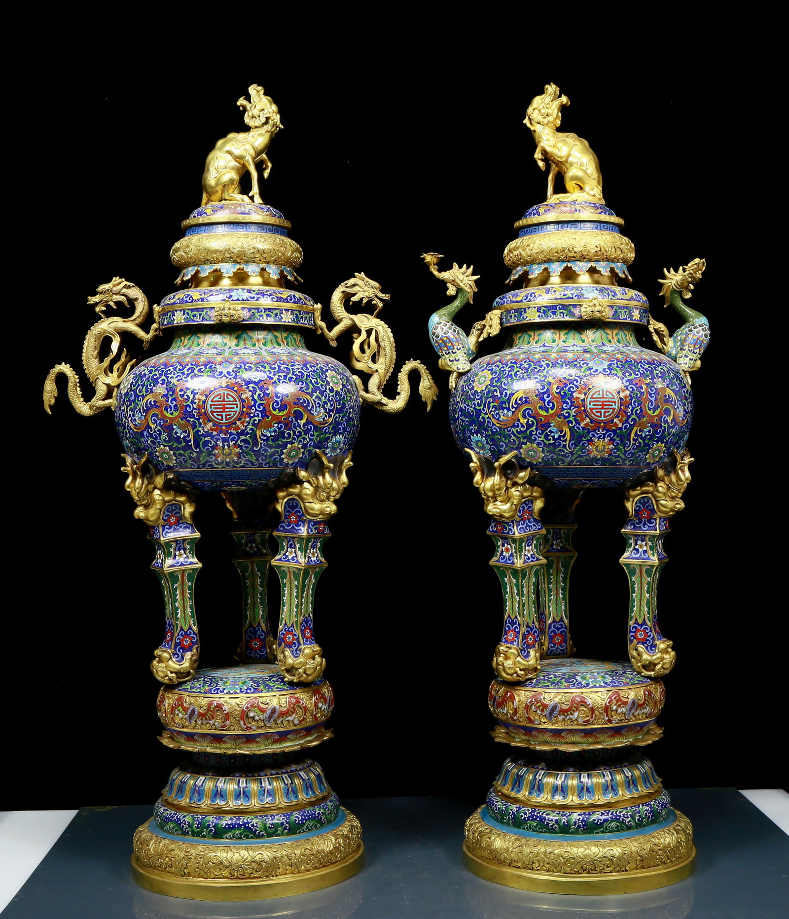 A pair of magnificent cloisonne lotus dragon pattern double-eared tripod censers with lids: A pair of magnificent cloisonné censers with twin ears and three legs with entwined branches, lotus and dragon pattern, with lids, six-character Qianlong period, Qing Dynasty, China. This pair of