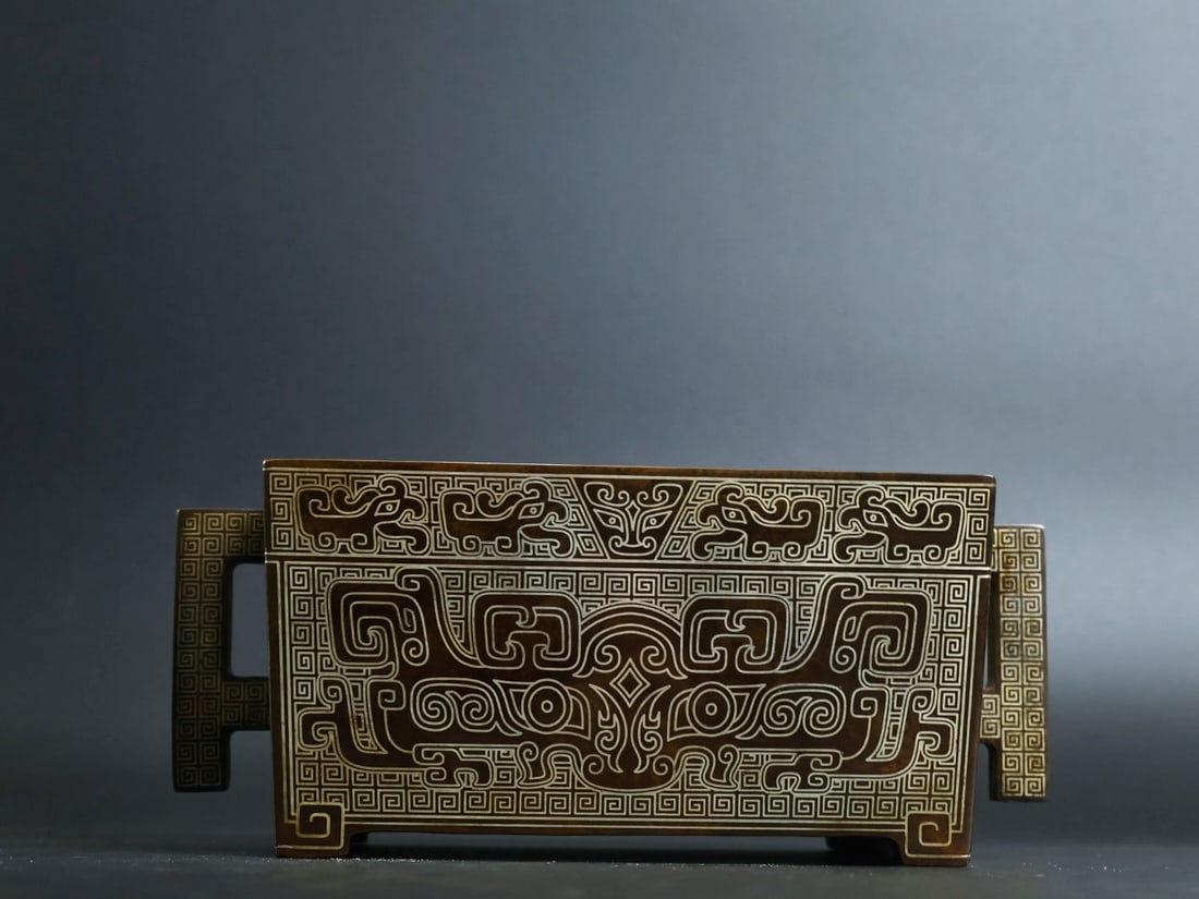 An Exquisite Bronze Inlaid Silver Beast-Face Pattern Double-Ears and Four-legs Censer: An Exquisite Bronze Inlaid Silver Beast-Face Pattern Double-Ears and Four-legs Censer,Qing Dynasty, China, With Mark,Size:3.1inx5.9inx3.9in,Weight:3125g 铜嵌银兽面纹