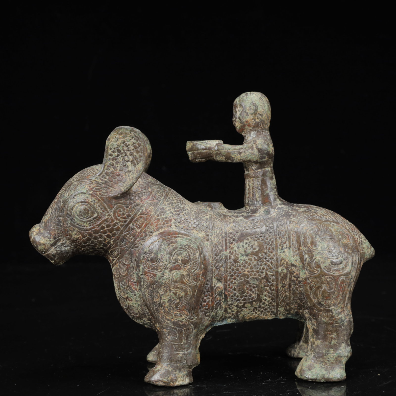 An Archaic Bronze Figure Riding Buffalo Ornament: An Archaic Bronze Figure Riding Buffalo Ornament,the Warring States Period in China,Size:7.1inx2.8inx5.9in,Weight:1050g 青铜人骑牛摆件,中国战