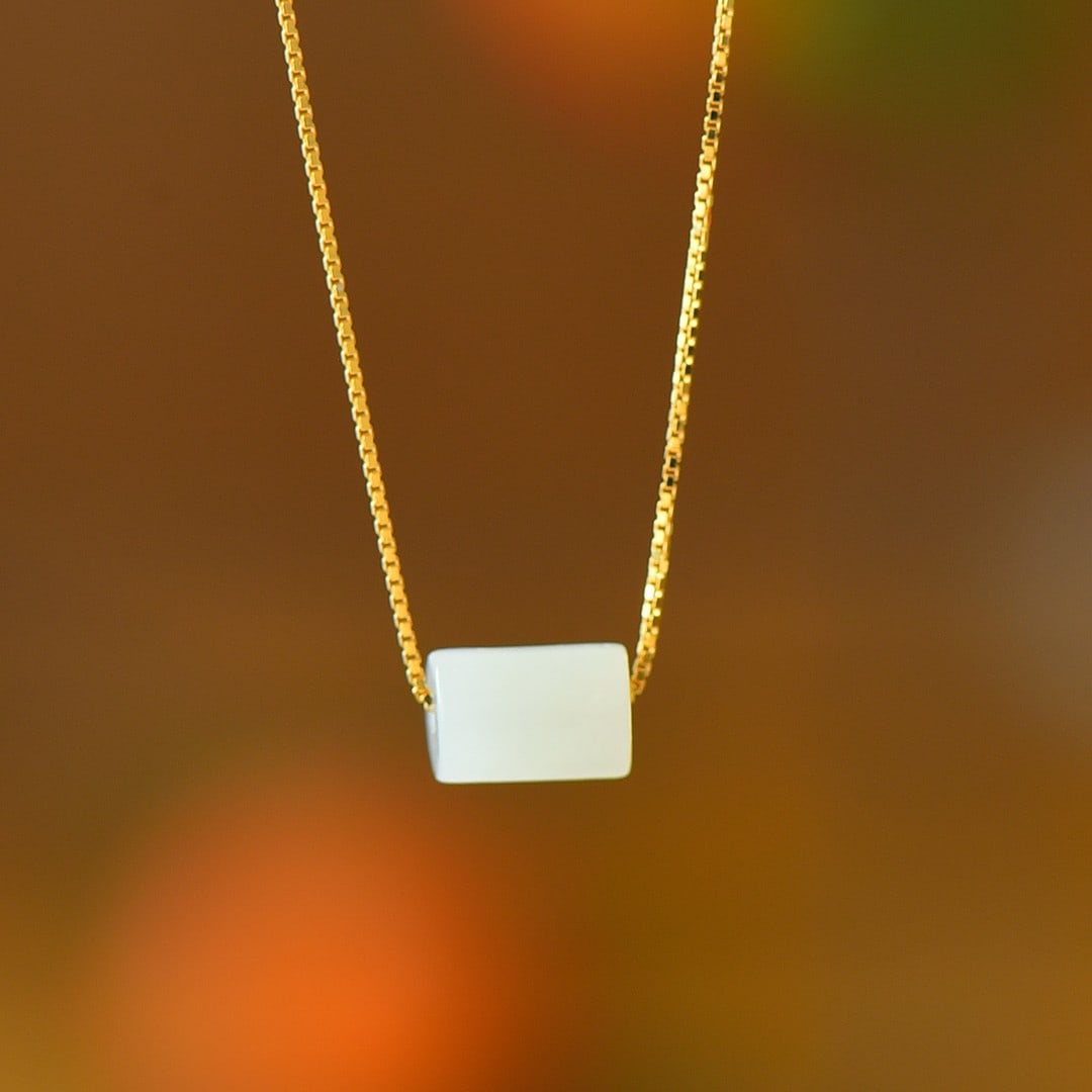 An Exquisite Sterling Silver-Gold Plated Inlaid White Jade Pendant: An Exquisite Sterling Silver-Gold Plated Inlaid White Jade Pendant,Size:0.2inx0.3in 纯银镀金镶白玉吊坠