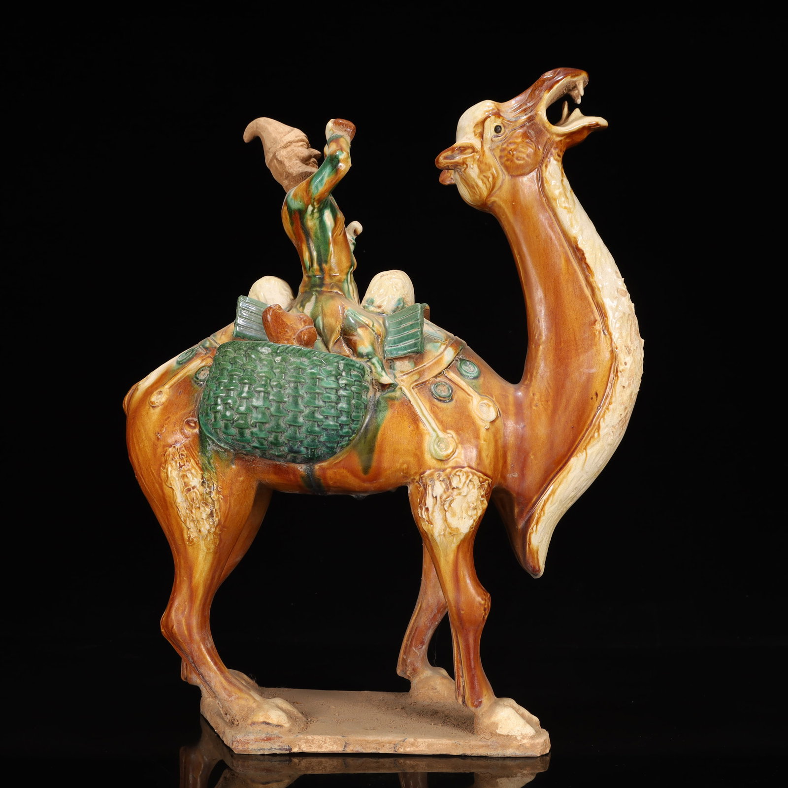 A Rare Tang Tri-Color Glazed Pottery Figure Riding Camel Ornament: A Rare Tang Tri-Color Glazed Pottery Figure Riding Camel Ornament,Tang Dynasty, China,Chinese Tang Tri-colored Pottery, or Tang Sancai, flourished during the Tang Dynasty (618–907 AD). It's reno