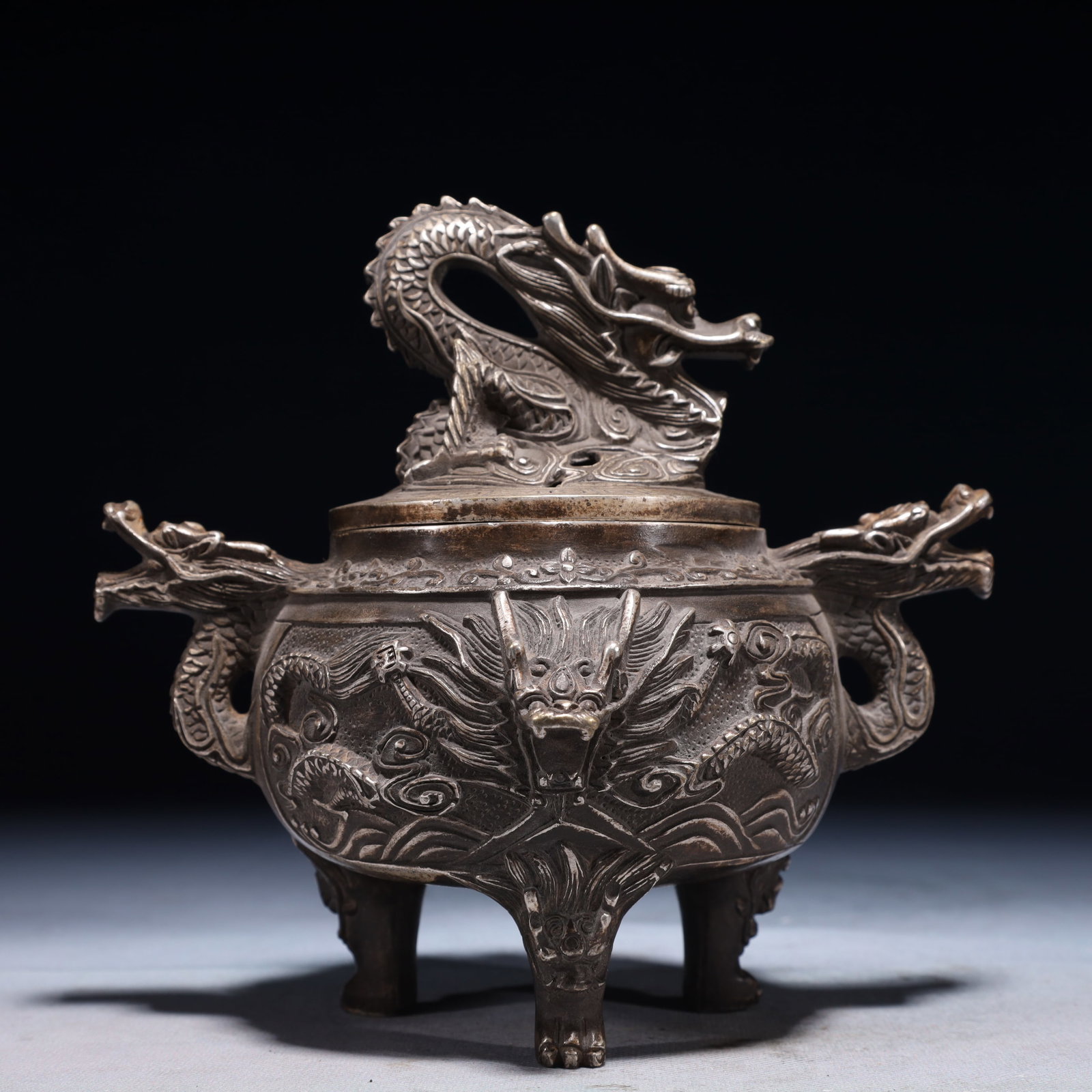 An Exquisite Silver-plated Bronze Auspicious Cloud and Dragon Pattern Double-Ears and Tripod Censer: An Exquisite Silver-plated Bronze Auspicious Cloud and Dragon Pattern Double-Ears and Tripod Censer,Ming Dynasty,China,Xuande Six-character Mark,Size:7.1inx5.5inx6.3in,Weight:1050g 铜镀