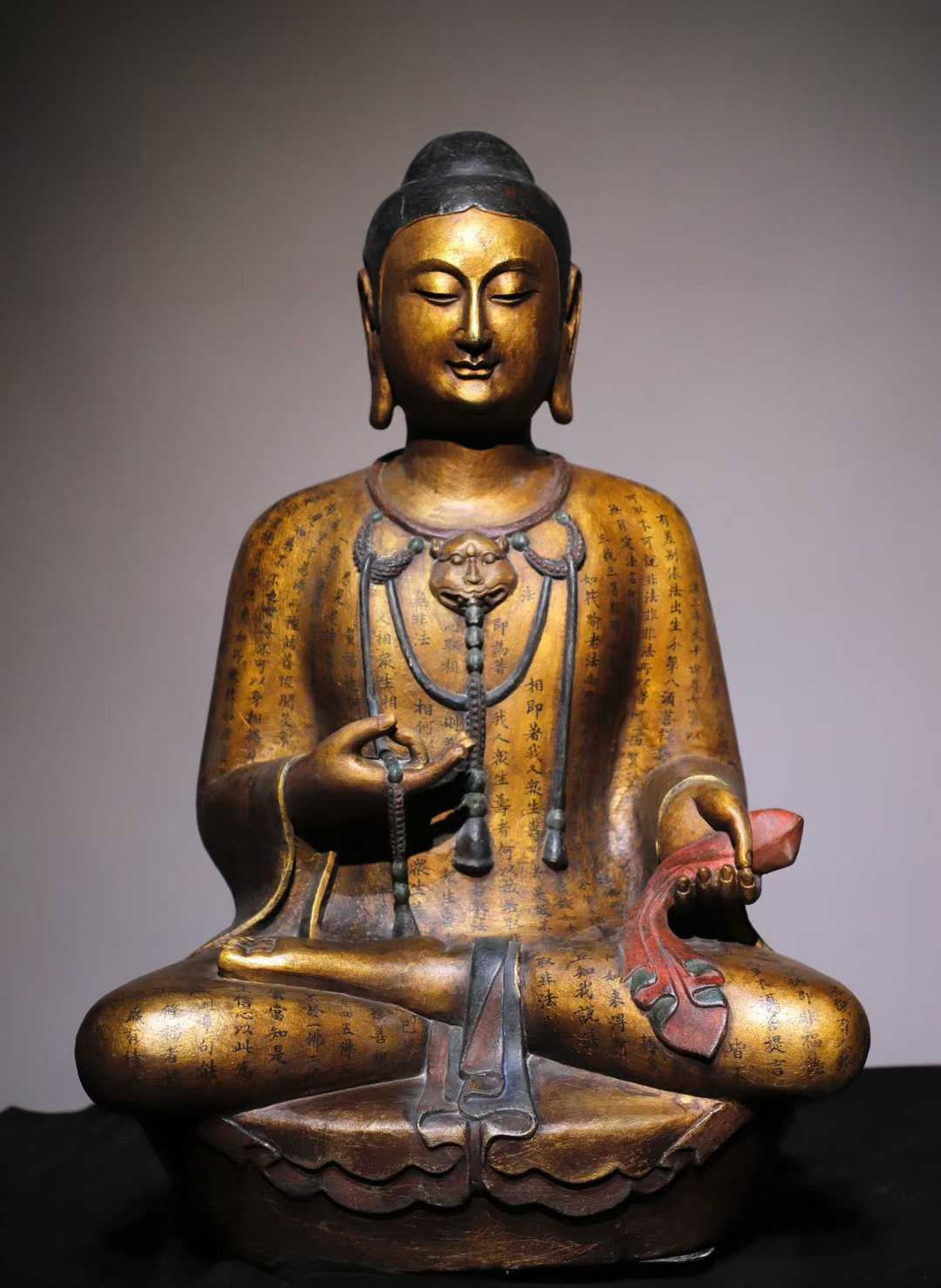 A Solemn Limestone Gilt Painted Color Statue of Sakyamuni,With Scriptures: A Solemn Limestone Gilt Painted Color Statue of Sakyamuni,With Scriptures,N.Qi,China,Size:26.8inx17.7inx12.6in 青石鎏金彩绘释迦摩尼像,