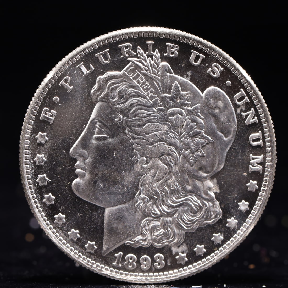 USA Morgan Dollar 1893 Coin: Obv: profile bust with date below and E PLURIBUS UNUM legend and stars around. Rev: eagle with In God we trust above within wreath with UNITED STATES OF AMERICA ONE DOLLAR legend. IN GOD WE TRUST / LI