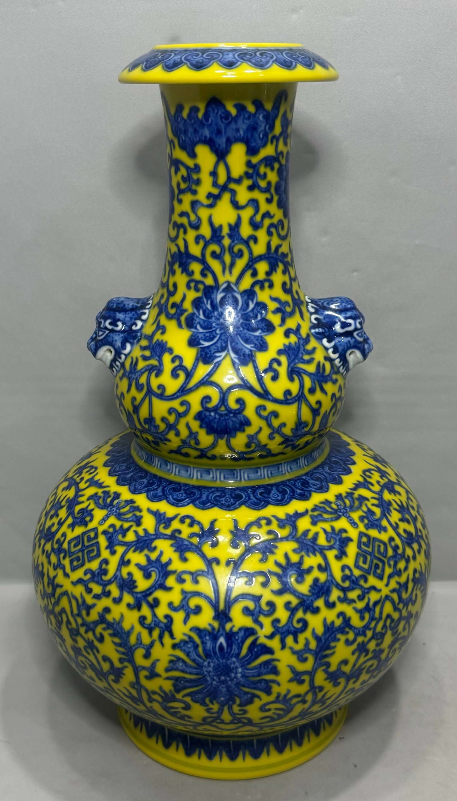 A Rare Yellow Ground Blue and White Lotus Pattern Beast-Ears Gourd-Shaped Vase: A Rare Yellow Ground Blue and White Lotus Pattern Beast-Ears Gourd-Shaped Vase,Qing Dynasty,China,Qianlong Six-character Mark,Size:13in 黄地青花缠枝莲纹