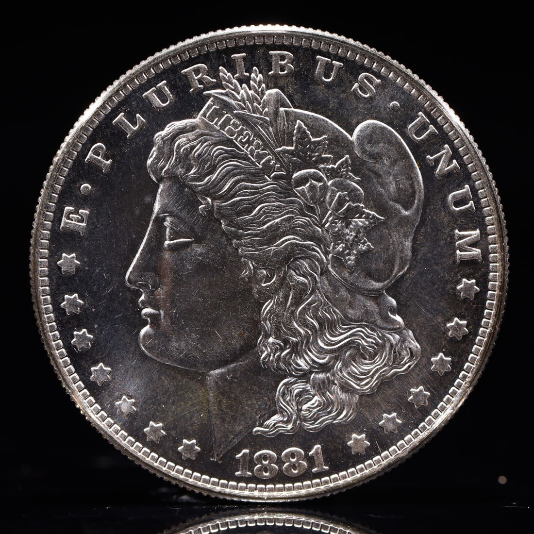 USA Morgan Dollar 1881 Coin: Obv: profile bust with date below and E PLURIBUS UNUM legend and stars around. Rev: eagle with In God we trust above within wreath with UNITED STATES OF AMERICA ONE DOLLAR legend. IN GOD WE TRUST / LI