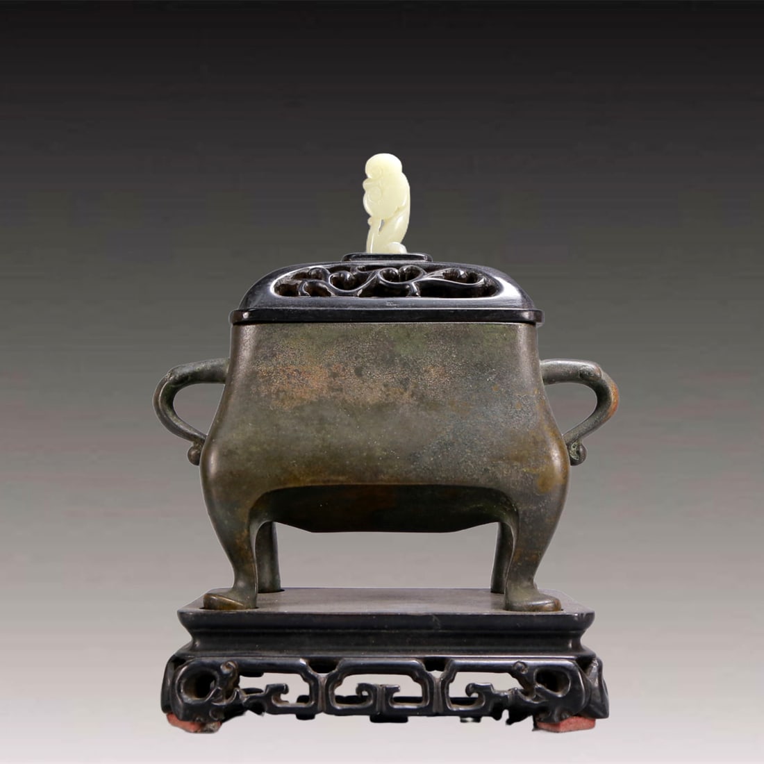 An Archaic Bronze Double-Ears and four legs Censer,with Zitanwood Inlaid White Jade Cover: An Archaic Bronze Double-Ears and four legs Censer,with Zitanwood Inlaid White Jade Cover,Ming Dynasty, China,Xuande Six-character Mark,Size:7.3inx3inx8.3in,Weight:2650g 铜双耳ࢯ