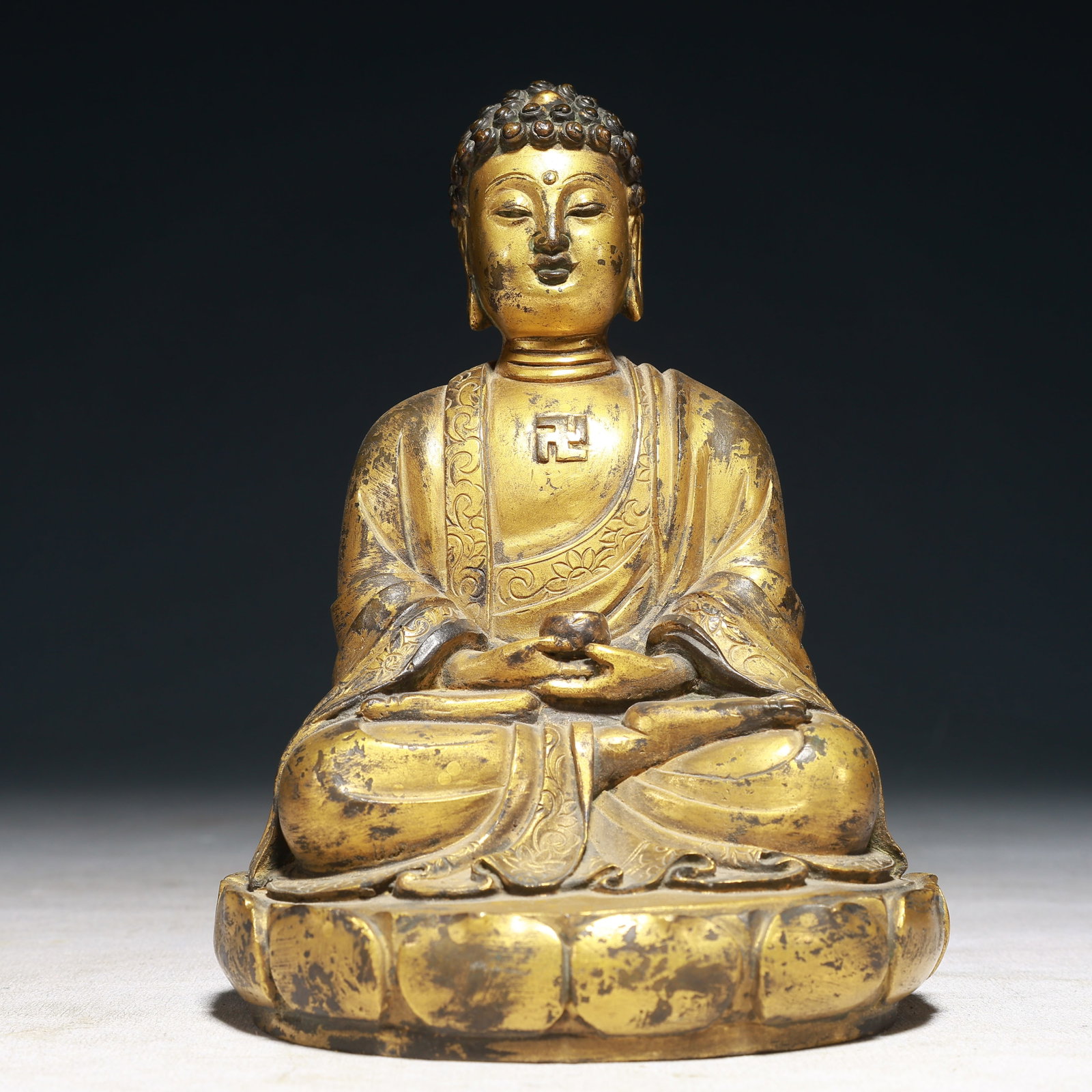 A Solemn Gilt Bronze Statue of Sakyamuni: A Solemn Gilt Bronze Statue of Sakyamuni,Qing Dynasty,China,Size:4.7inx6.3in,Weight:1900g 铜鎏金如来像,中国清代