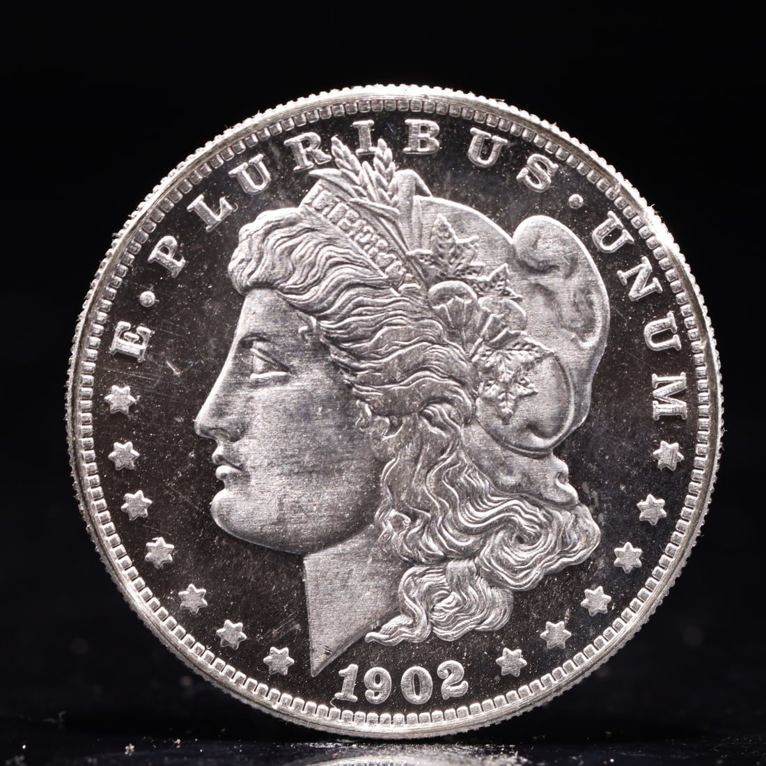 USA Morgan Dollar 1902 Coin: Obv: profile bust with date below and E PLURIBUS UNUM legend and stars around. Rev: eagle with In God we trust above within wreath with UNITED STATES OF AMERICA ONE DOLLAR legend. IN GOD WE TRUST / LI