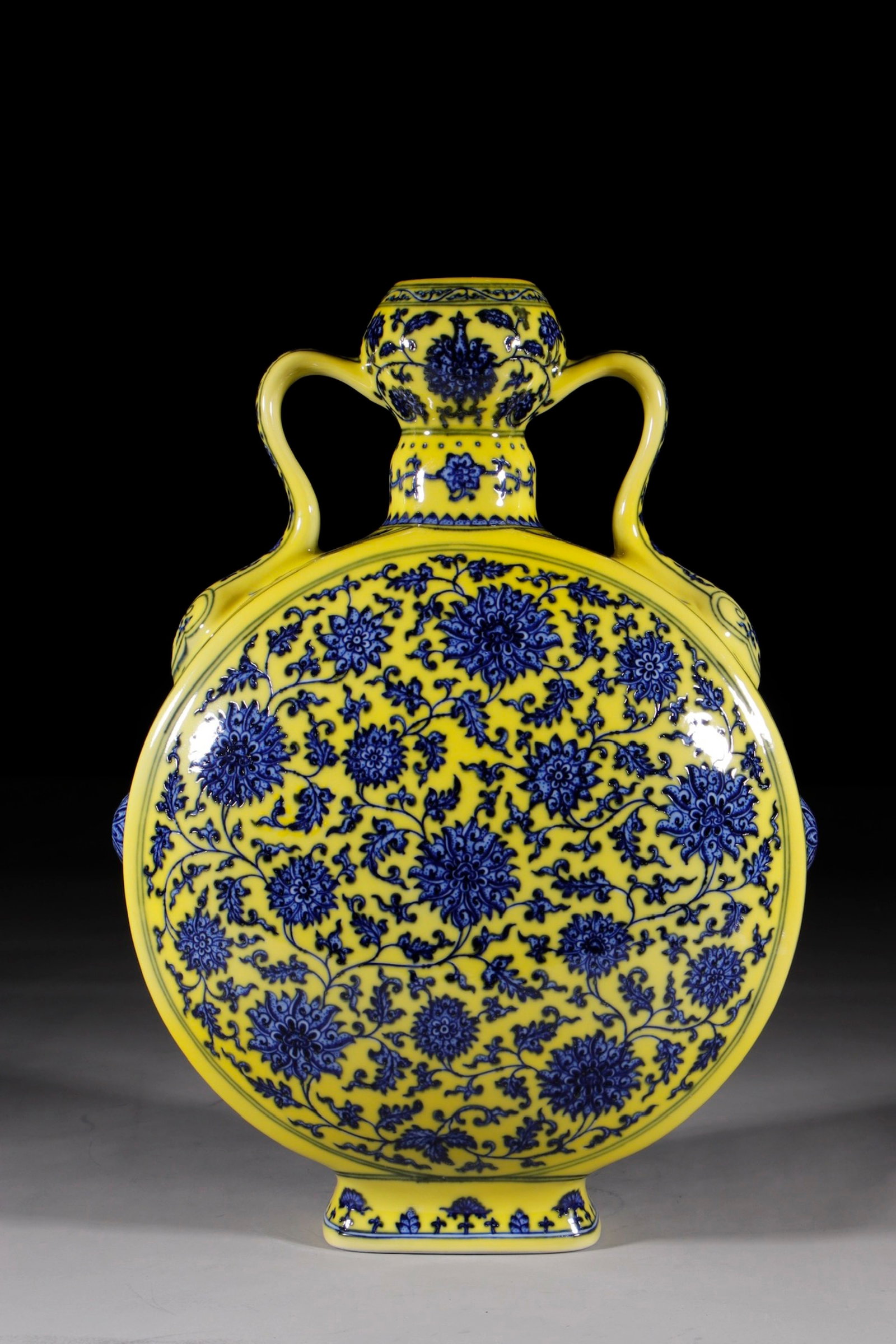 A Huge Yellow Ground Blue and White Lotus Pattern Double-Ears Vase: A Huge Yellow Ground Blue and White Lotus Pattern Double-Ears Vase,Qing Dynasty,China,Qianlong Six-character Mark,Size:16.1in 黄地青花缠枝莲纹双&#
