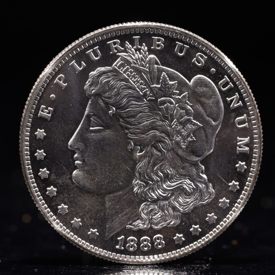 USA Morgan Dollar 1888 Coin: Obv: profile bust with date below and E PLURIBUS UNUM legend and stars around. Rev: eagle with In God we trust above within wreath with UNITED STATES OF AMERICA ONE DOLLAR legend. IN GOD WE TRUST / LI