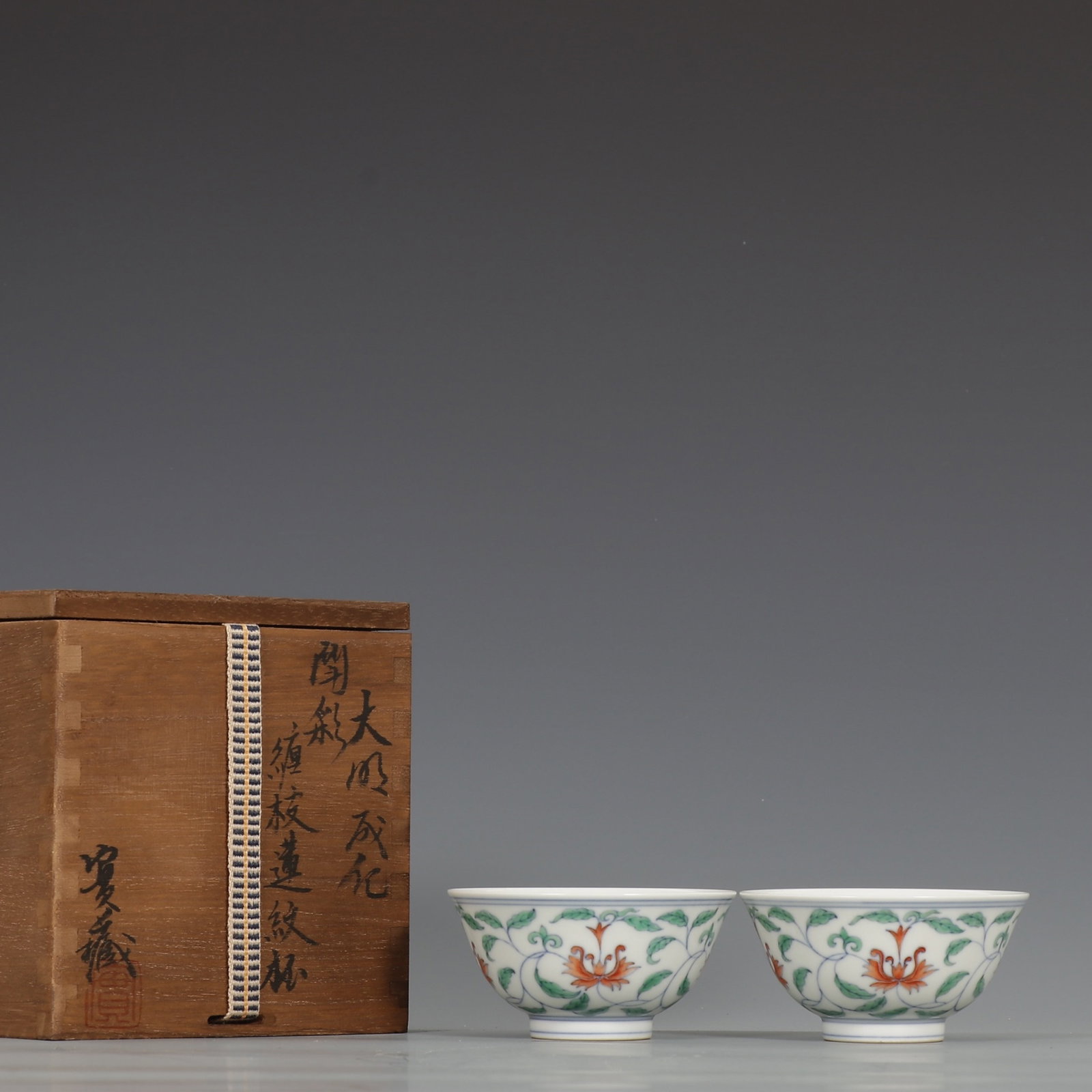 A Pair of Exquisite Doucai Lotus Pattern Cups: A Pair of Exquisite Doucai Lotus Pattern Cups,Ming Dynasty,China,Chenghua Six-character Mark,Size:1.8inx3.5in 一对斗彩缠枝莲纹杯子,中&