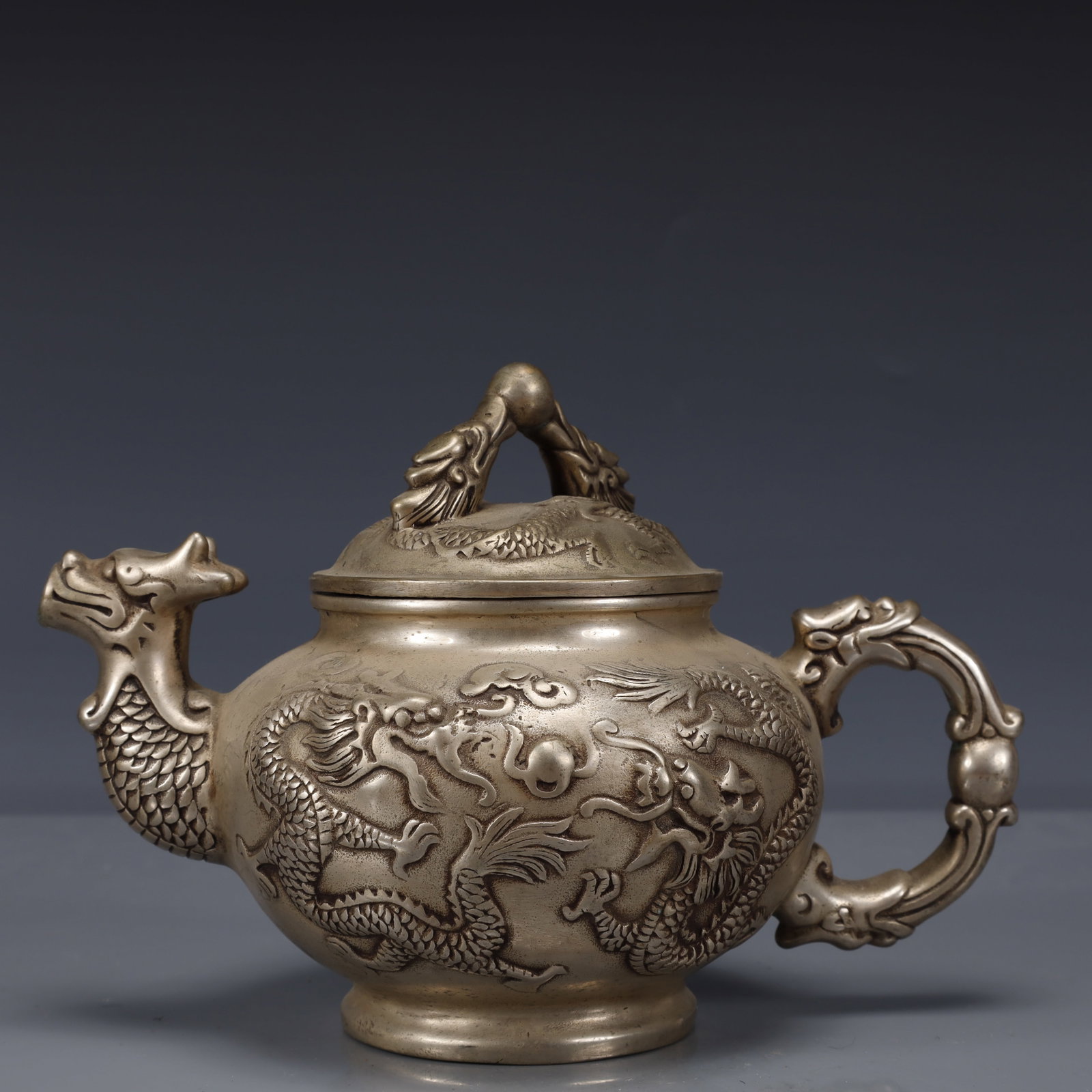 An Exquisite Silver-Plated Bronze Dragon Pattern Ewer: An Exquisite Silver-Plated Bronze Dragon Pattern Ewer,Qing Dynasty, China,With Mark,Size:7.9inx5.1inx5.9in,Weight:1050g 铜镀银龙纹执壶,中国清
