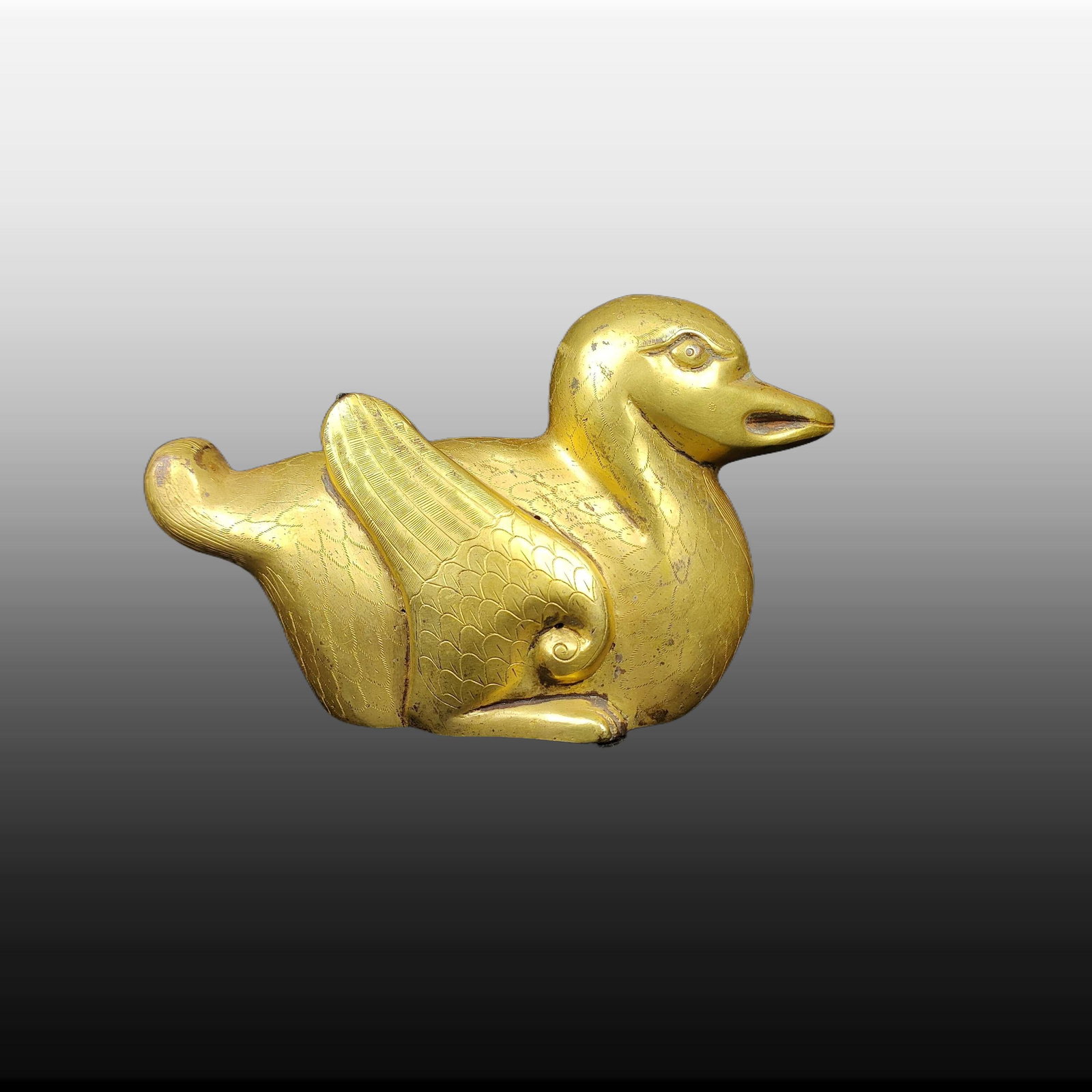 A Exquisite Gilt Bronze Duck-shaped Paper Weight: A Exquisite Gilt Bronze Duck-shaped Paper Weight,Ming Dynasty, China,Size:3.1inx4.7in,Weight:379g 铜鎏金鸭形镇纸,中国明代